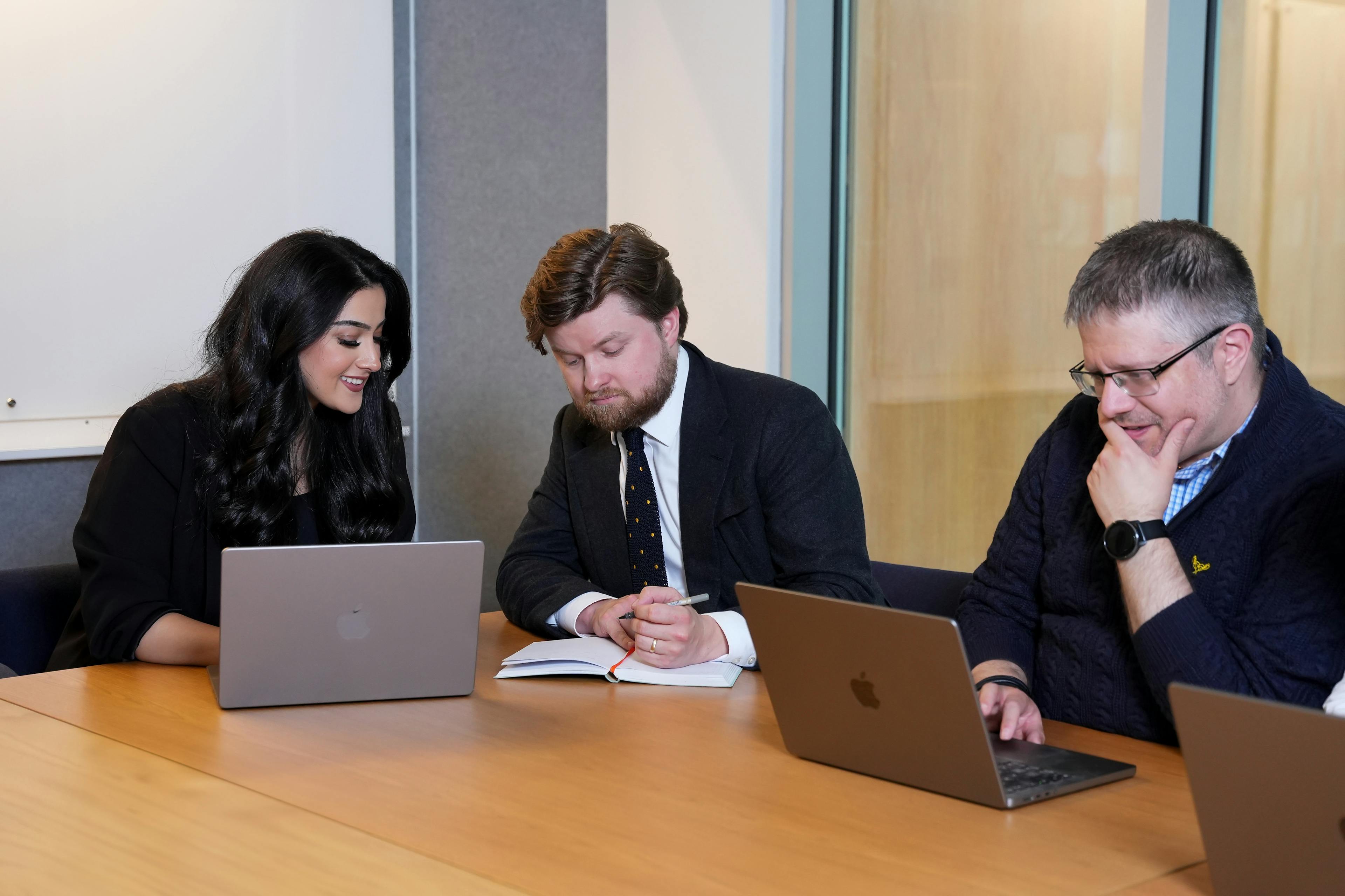 Three seniors working in boardroom 