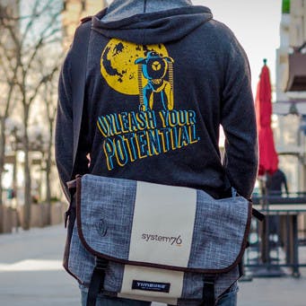System76 laptop bag and person wearing a system76 jacket