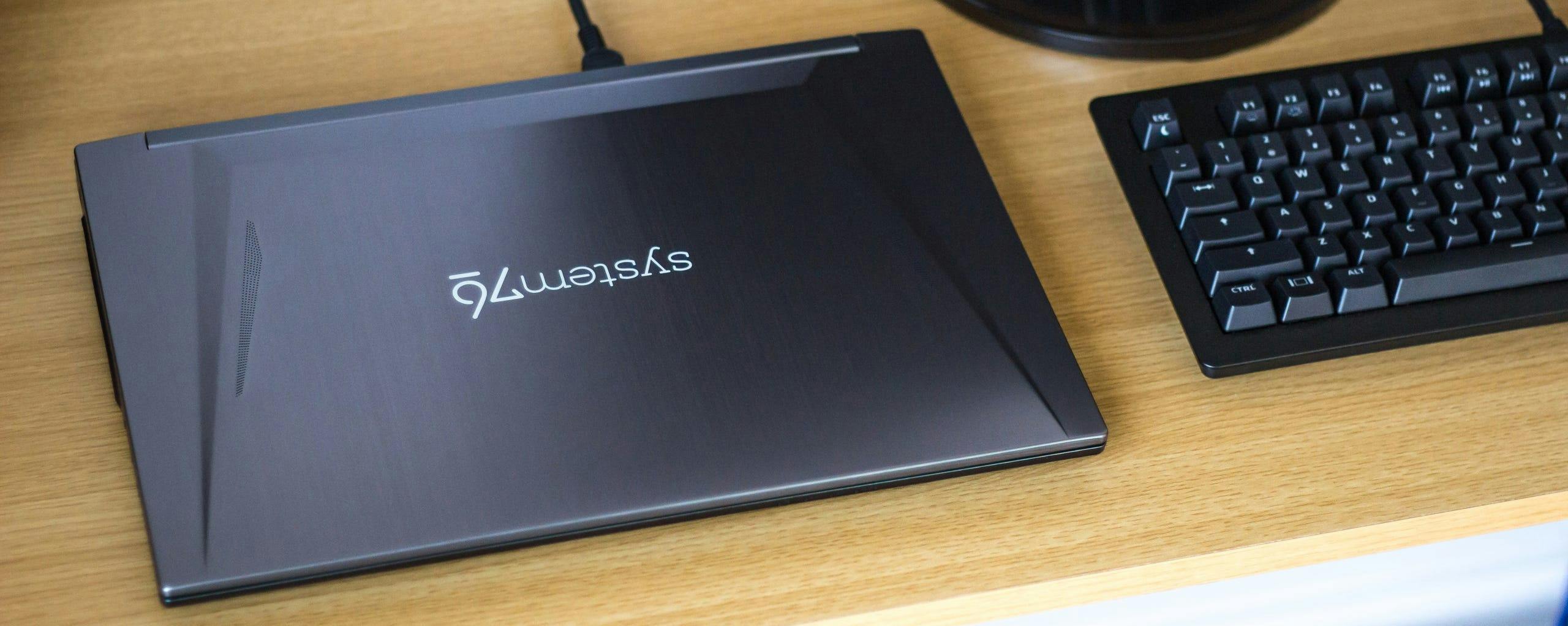 The Gazelle laptop on a desk next to a computer keyboard and external monitor.