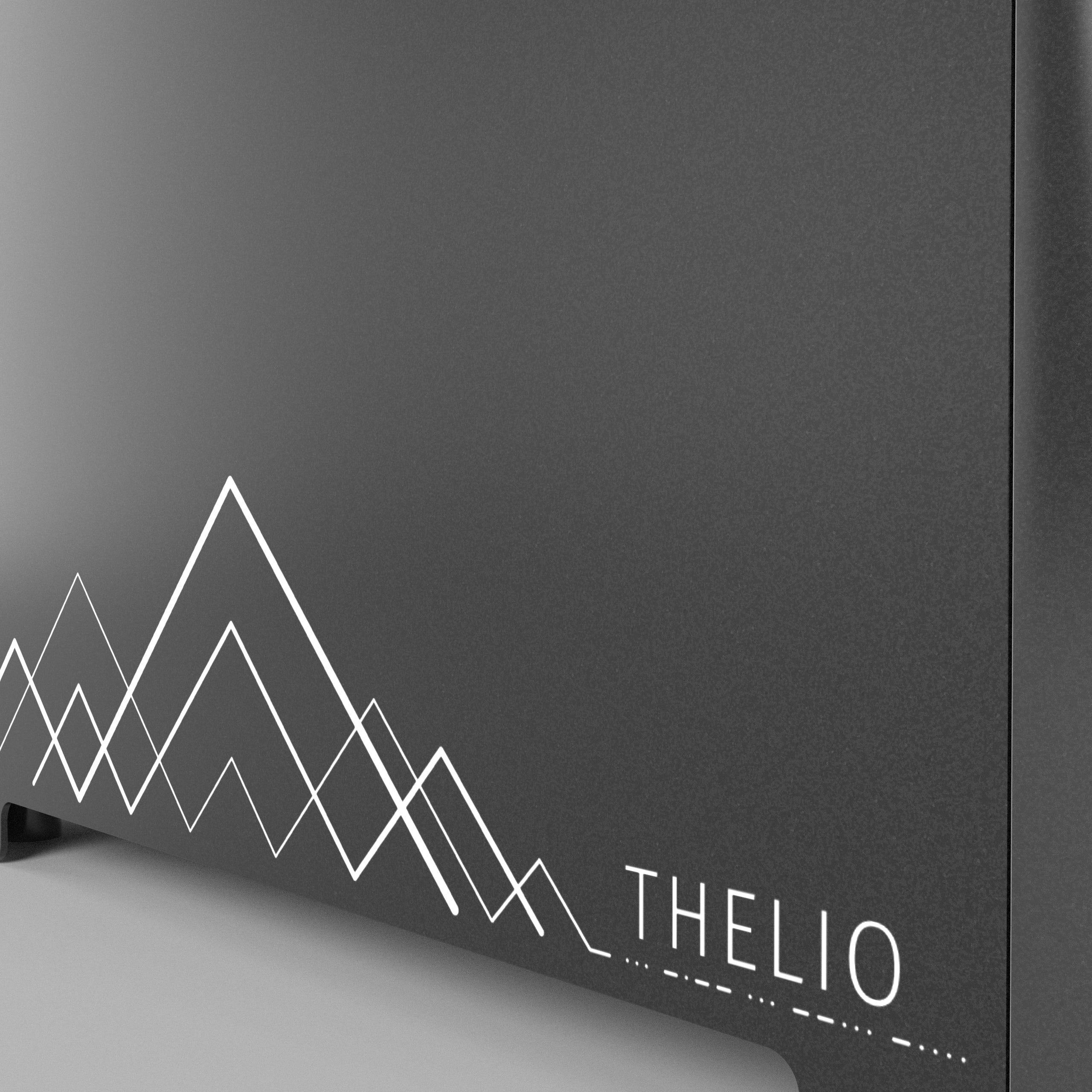 Detail of the machine exterior showing geometric etching of mountains.