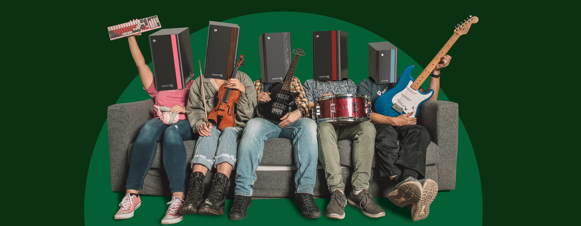 The band members of Theliohead holding instruments and sitting on a grey couch