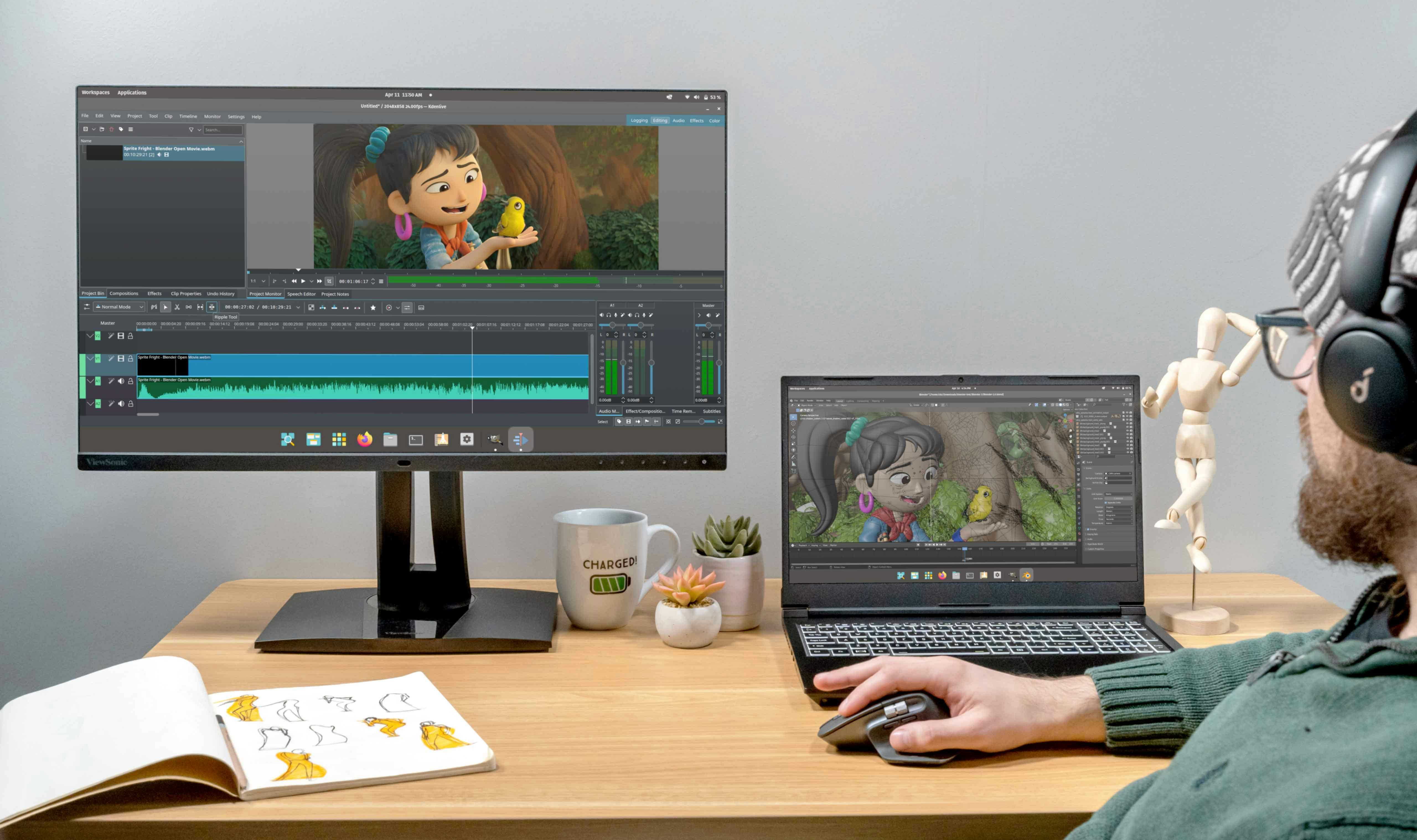An animator uses an Adder laptop to edit an animation connected to a monitor.
