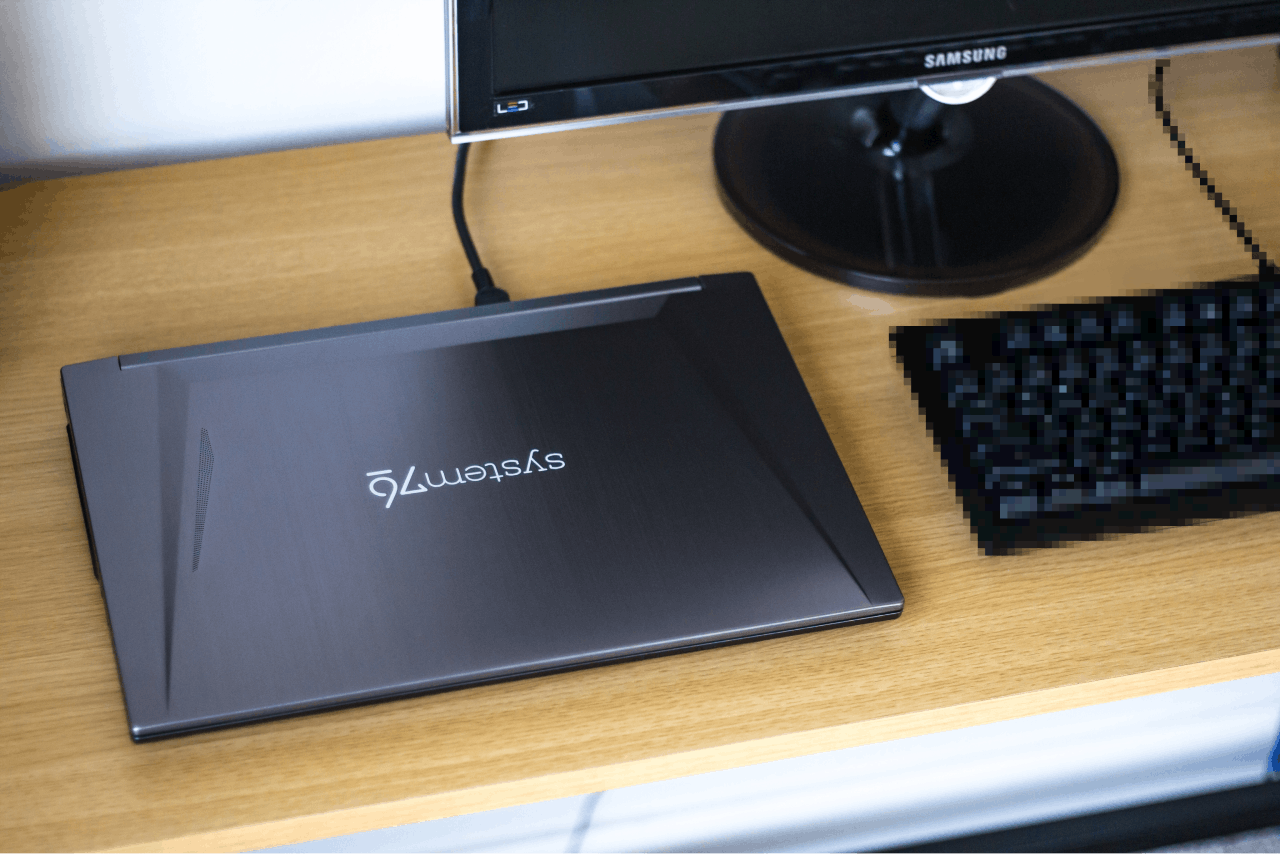 The Gazelle laptop on a desk next to a computer keyboard and external monitor.