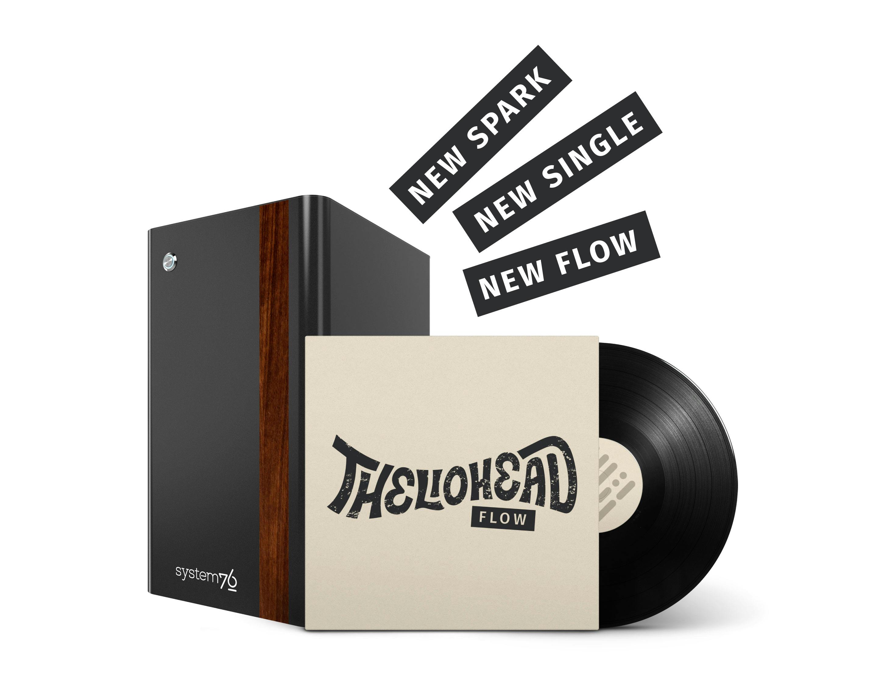 THELIOHEAD viynal album with logo sits in front of Thelio Mira computer with walnut accent. Text above reads "New Spark, New Single, New Flow".