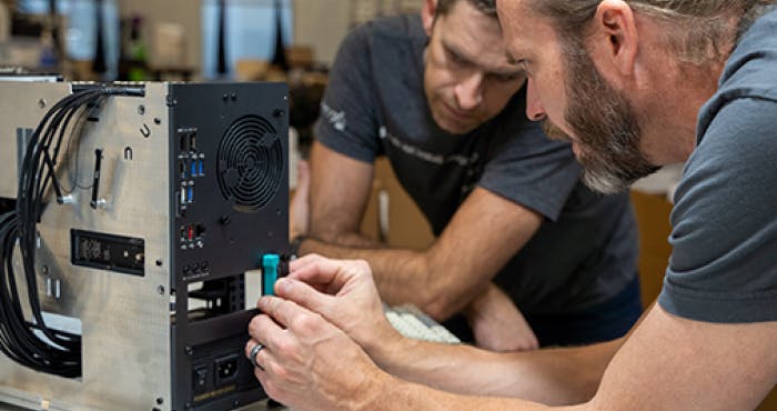 CEO Carl Richell and Mechanical Engineer John Grano servicing open source Thelio hardware.