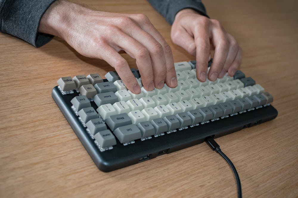 A person typing on the keyboard while their hands stay on the home row.
