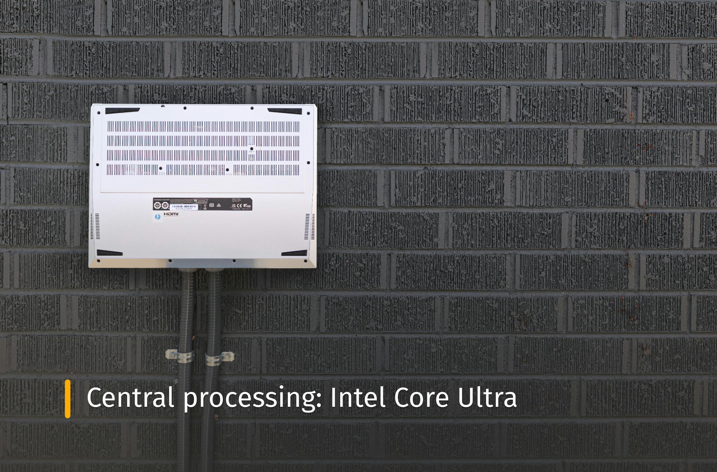 Darter Pro outside next to the side of a house with pipes coming out of it with text that reads "Central processing: Intel Core Ultra"