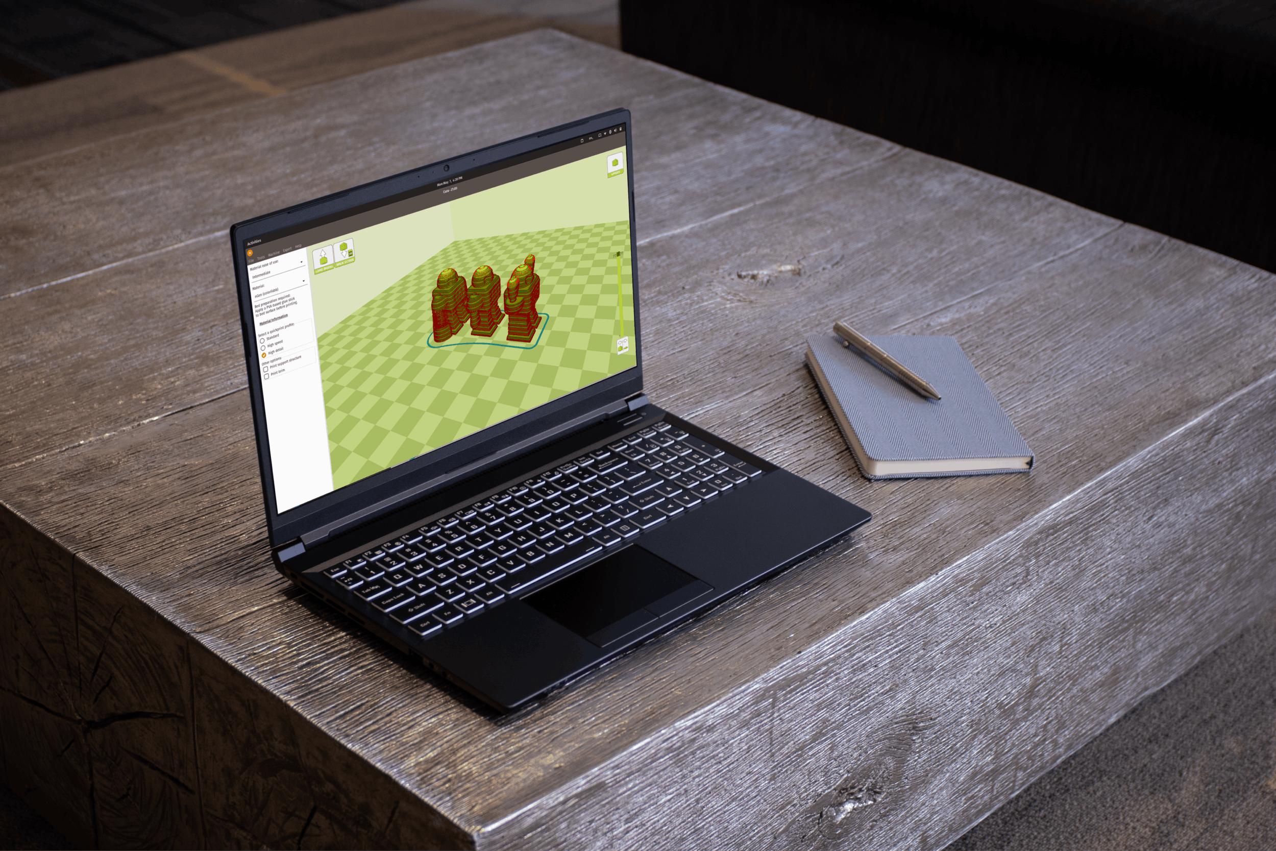 The Oryx Pro laptop showing three excited robots in the 3D-printing software, Cura.