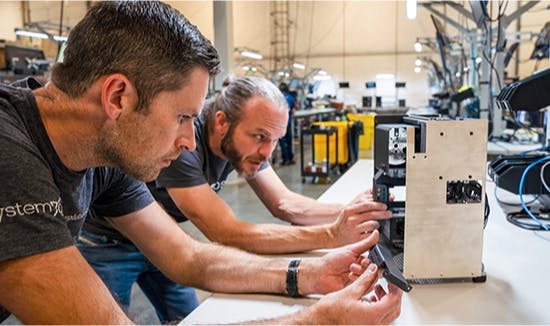 Two engineers testing a Thelio.