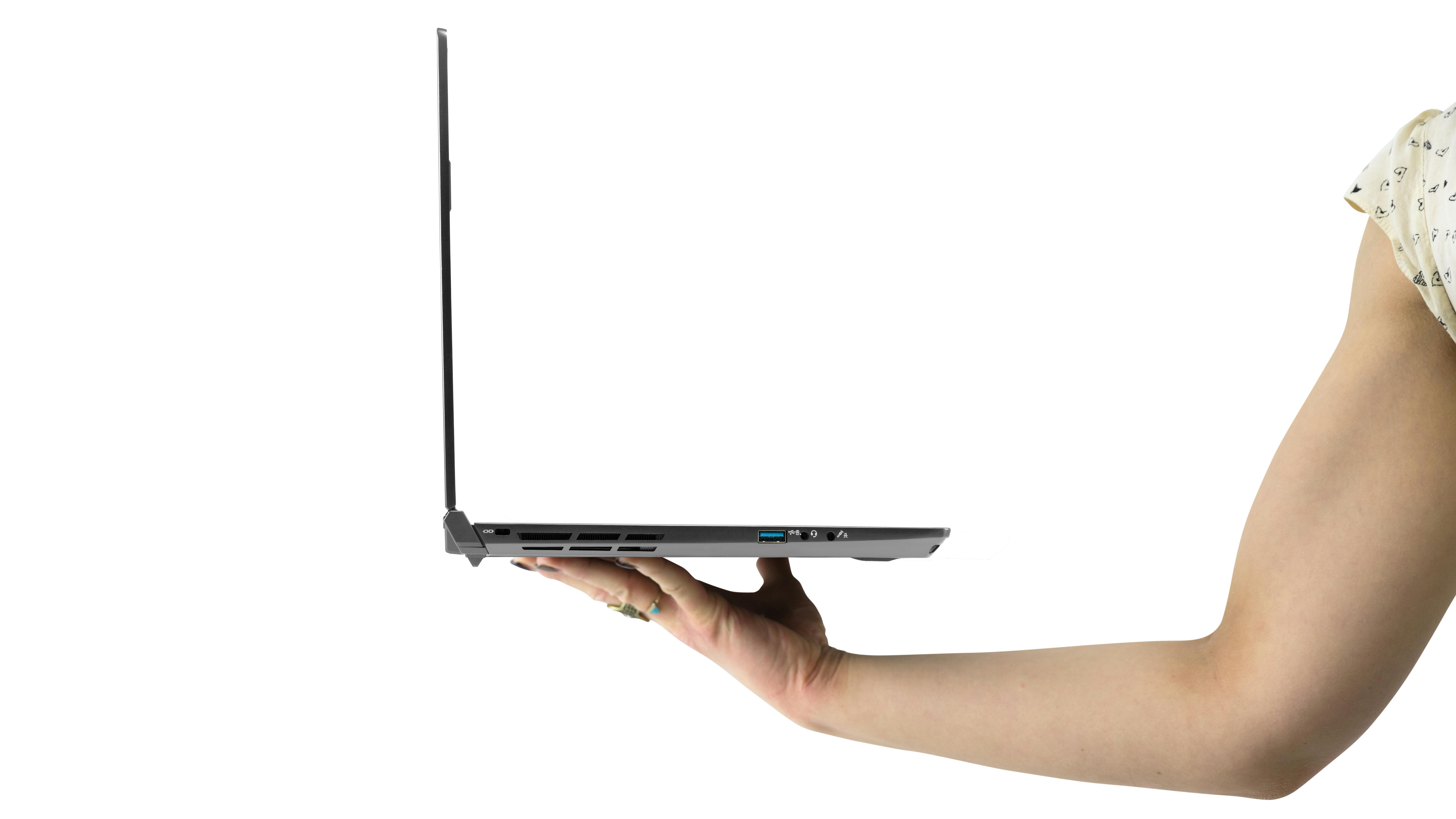 Someone holding the slim Oryx Pro laptop with one hand.