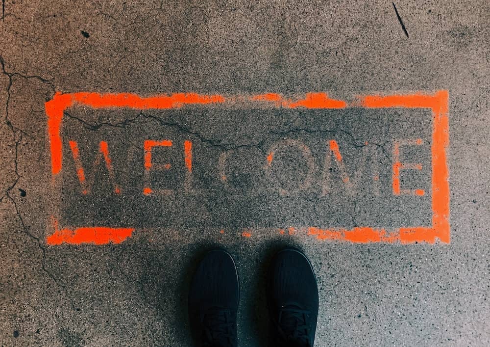 'Welcome' spray-painted on the ground.