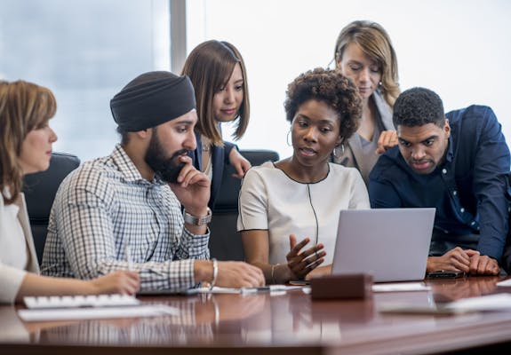 Group of diverse workers in a meeting room.