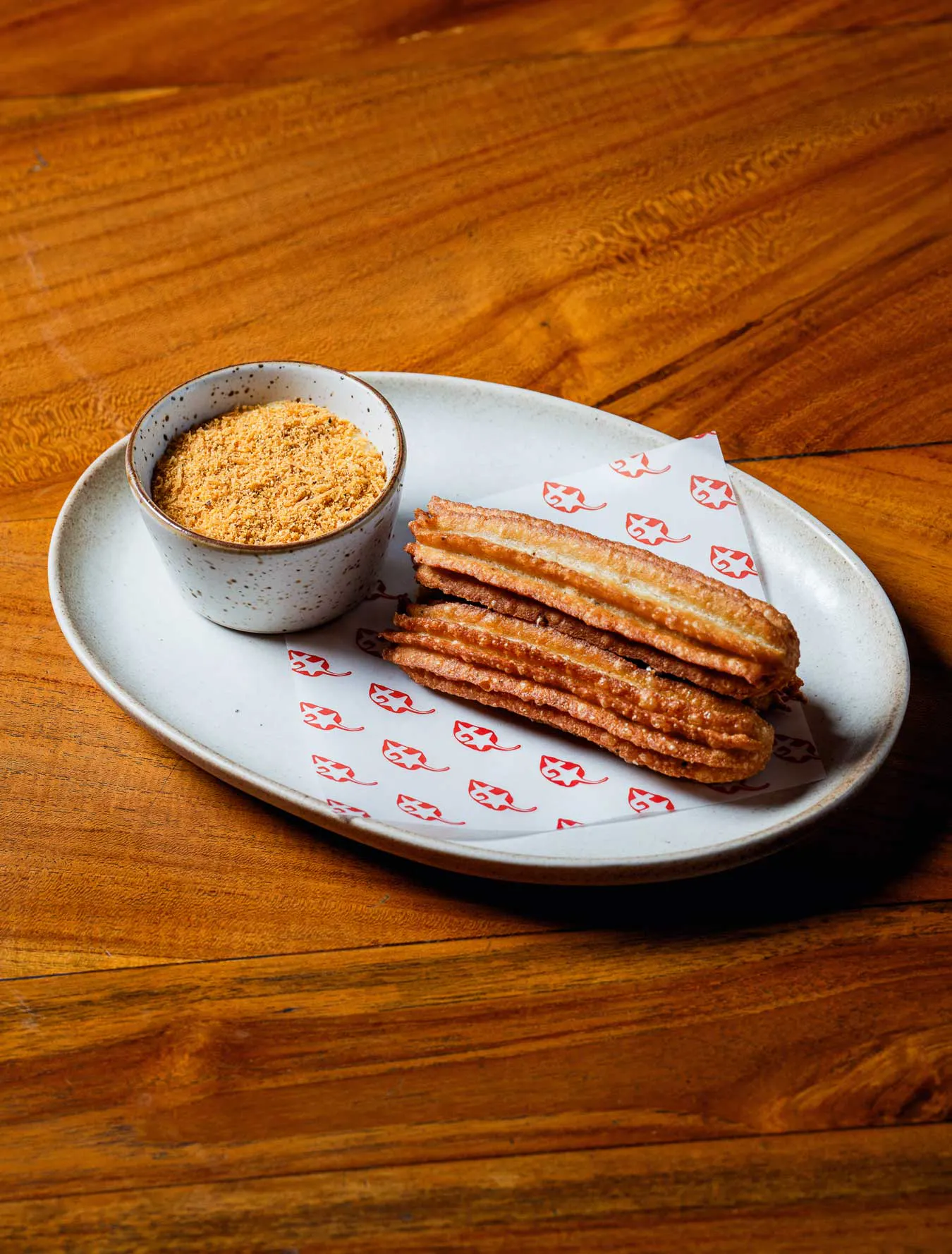 crispy looking churros on a wooden table