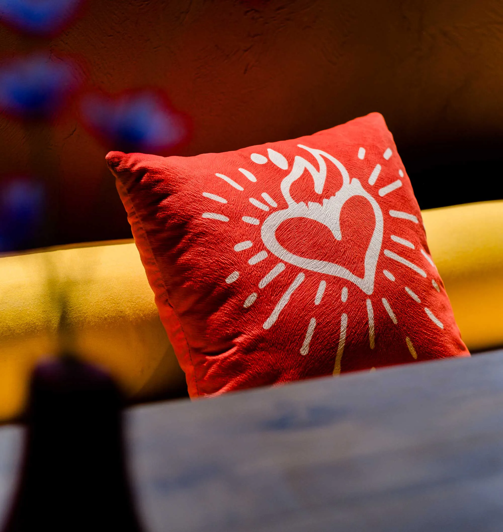 Red embroidered cushion with a sacred heart design at Tacos Aqui Mexican restaurant in Bali