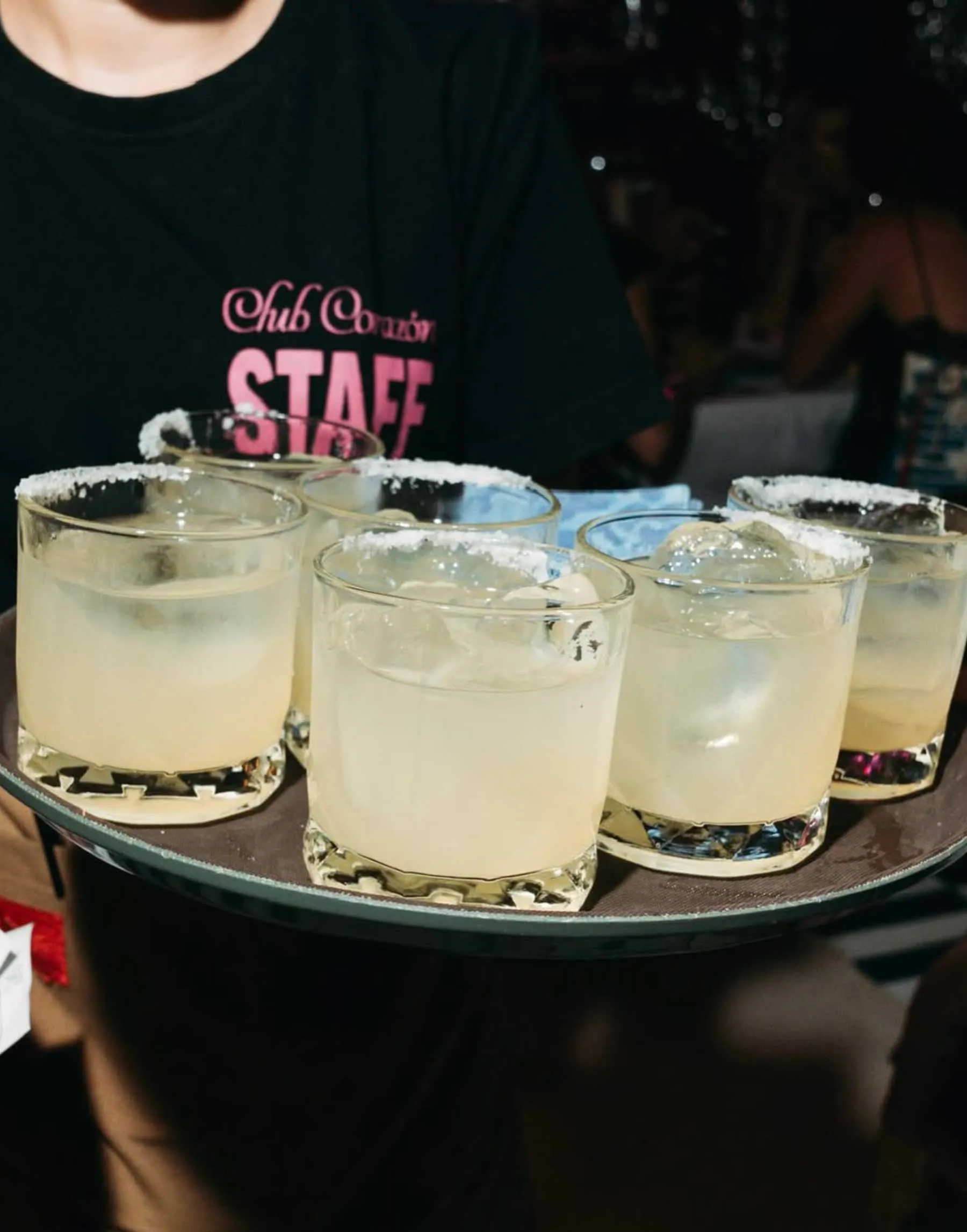 Club Corazon staff member serving a tray of margaritas with salted rims at a private function in Uluwatu Bali