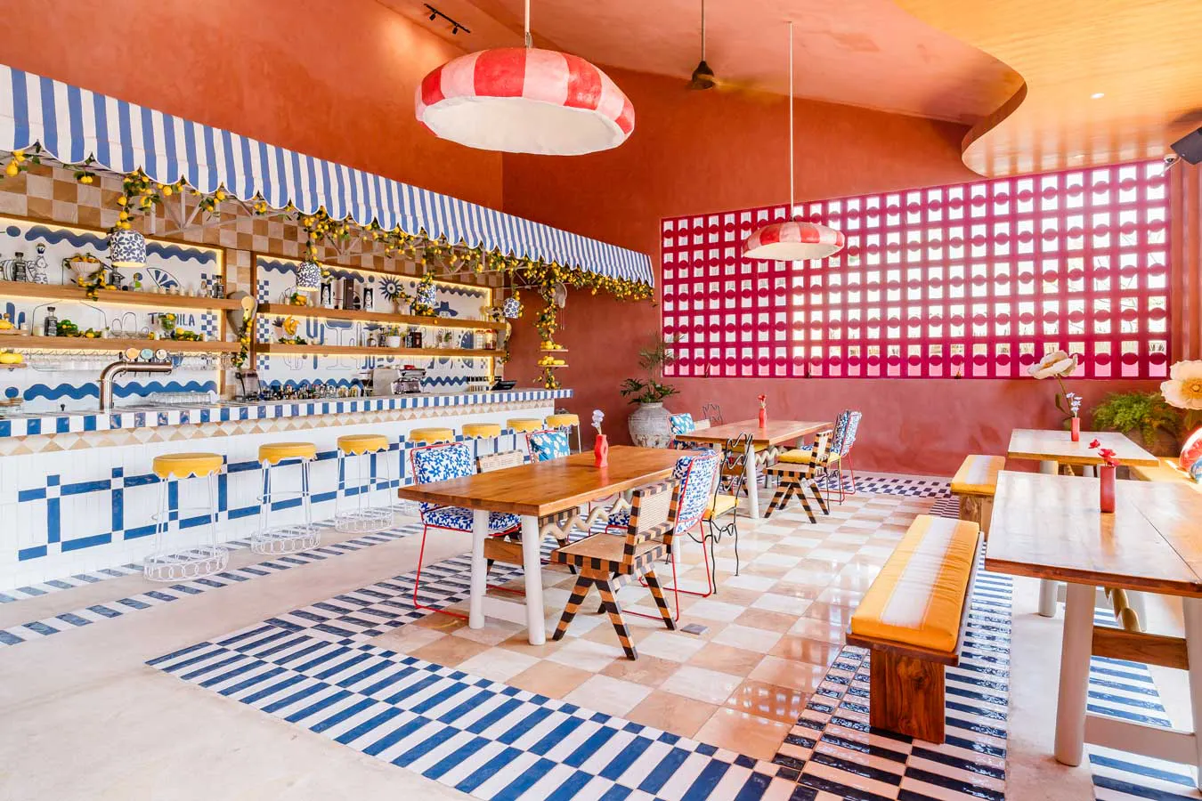 Blue and white tiled bar with yellow bar stools at Mexican restaurant in Uluwatu Bali