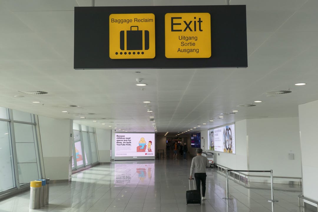 Luggage and exit signs in Brussels Airport