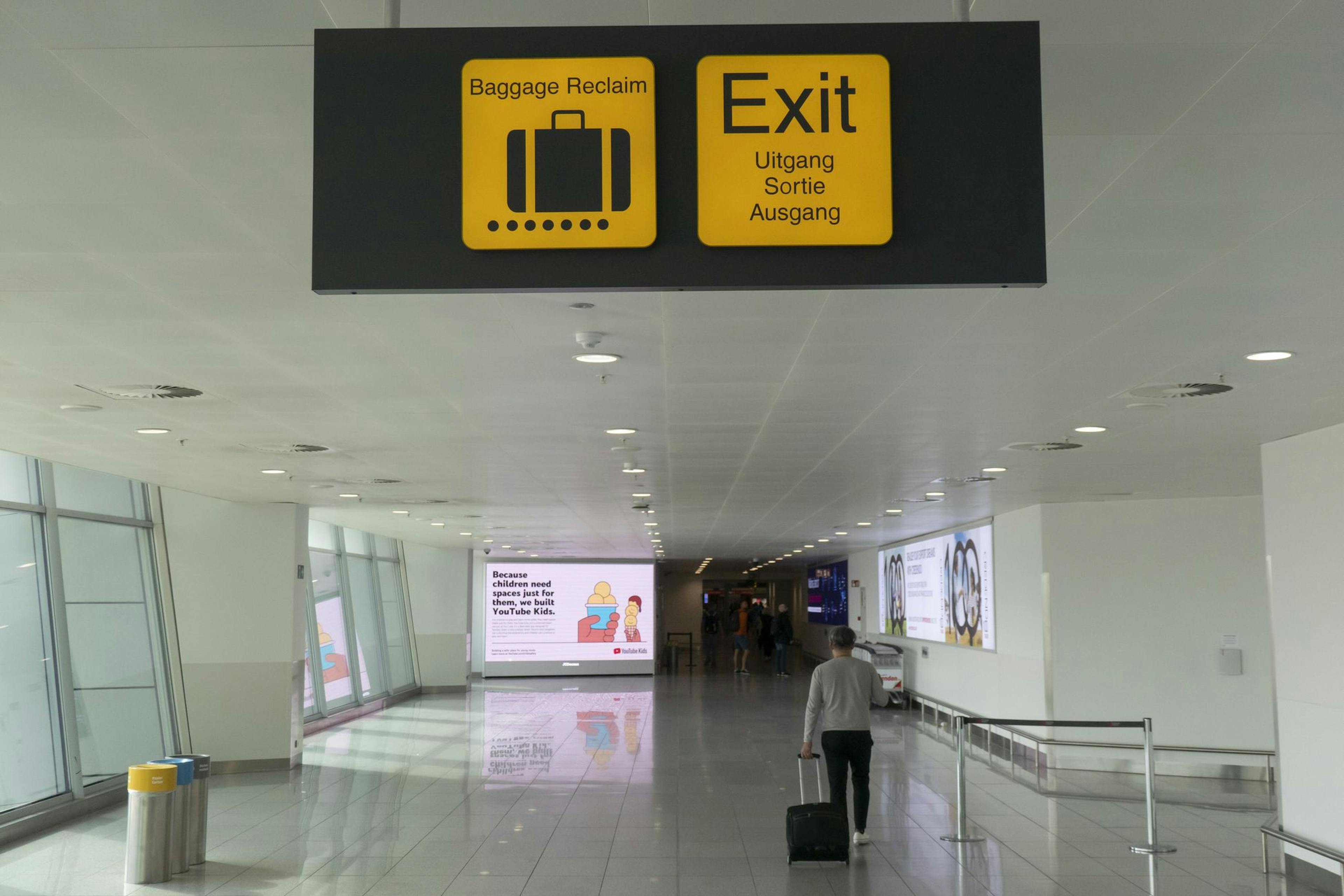 Luggage and exit signs in Brussels Airport