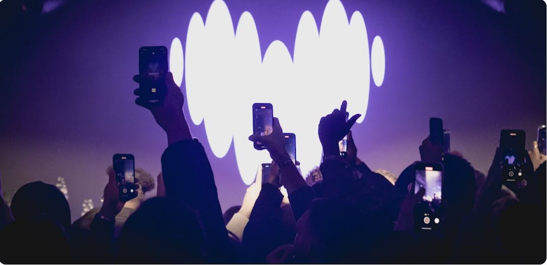 Crowd watching show with Deezer logo