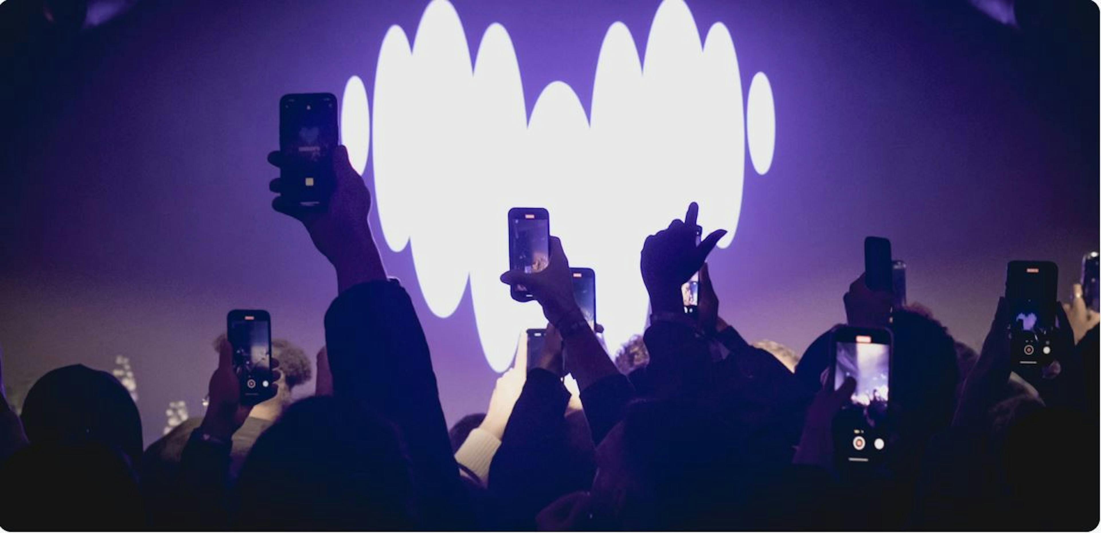 Crowd watching show with Deezer logo