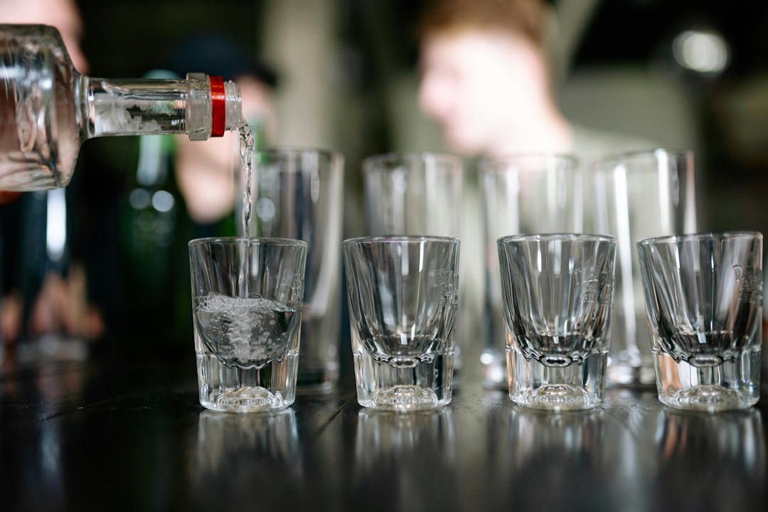 Vodka being poured into glasses