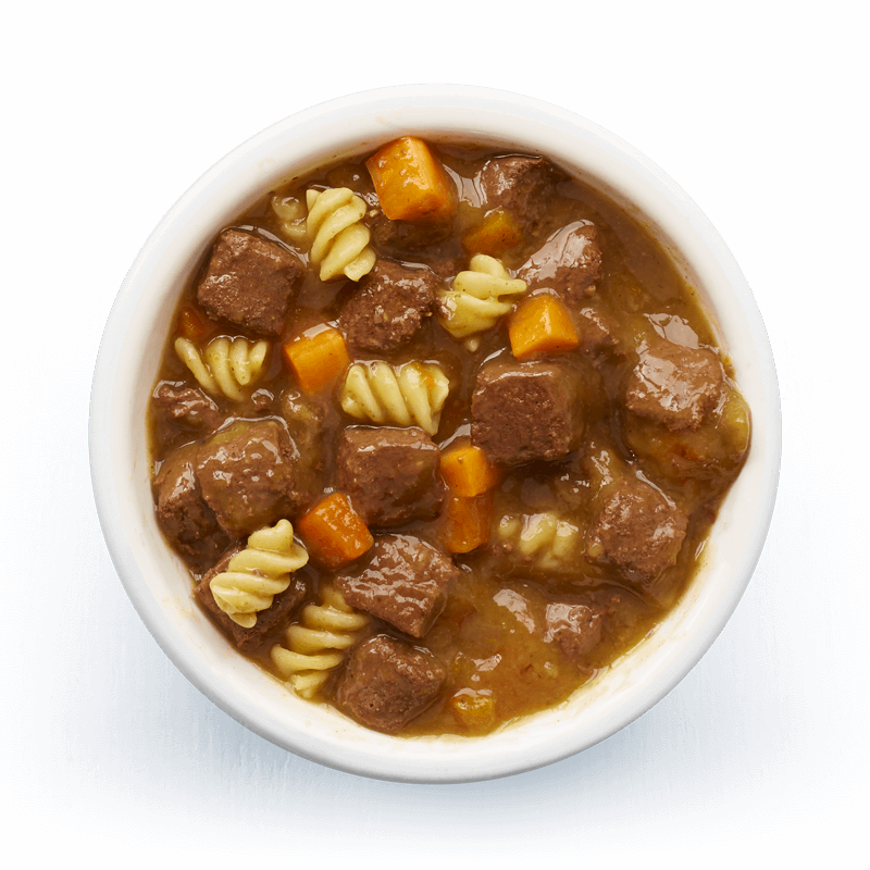An image of Tails wet food. Hearty casserole with beef, pasta & carrots in tasty gravy.