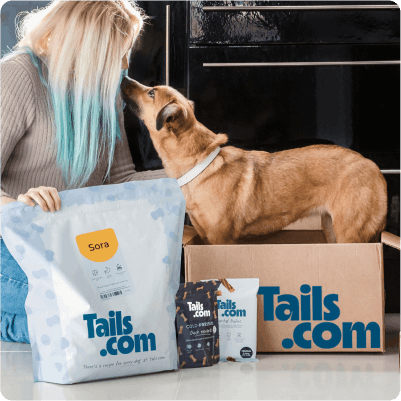 A happy customer with her tails.com delivery