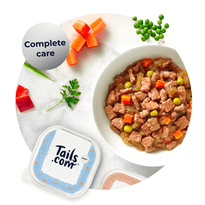 Complete Care wet food surrounded by fresh vegetables