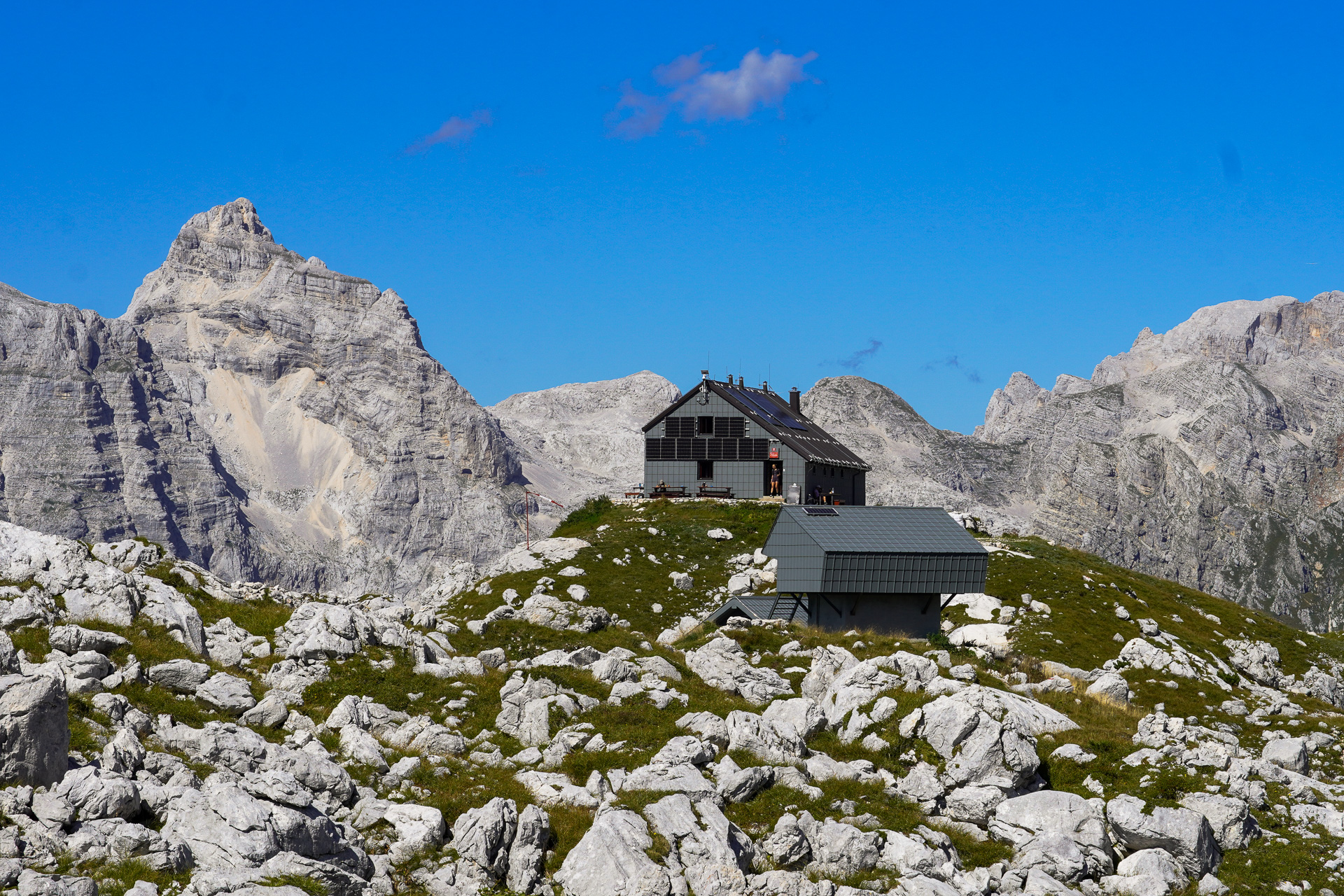 mountain hut on top of a rock.