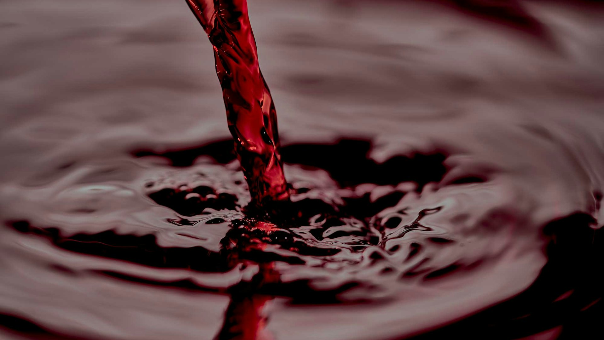 Close up of red wine being poured