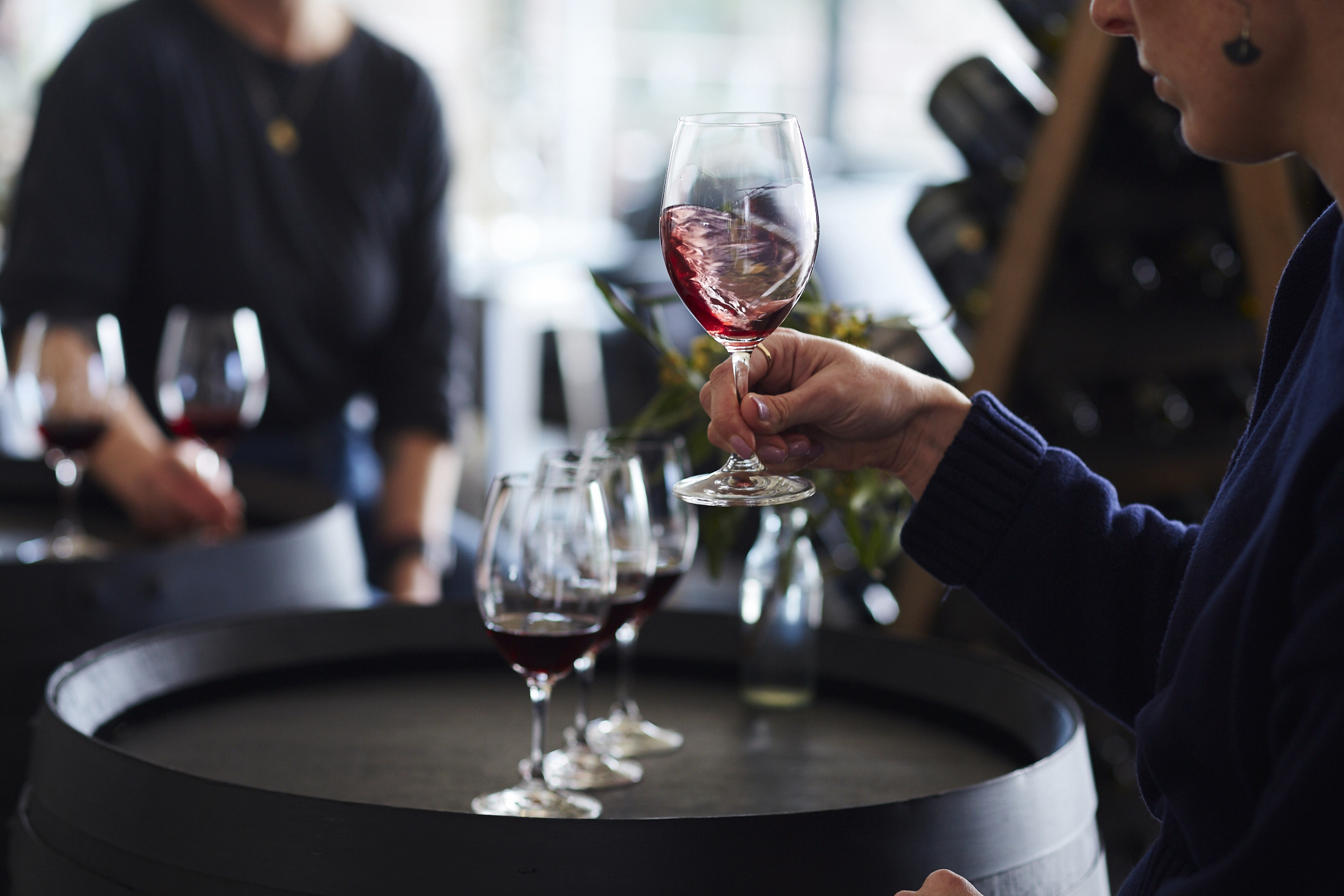 Girl swirling glass of red wine