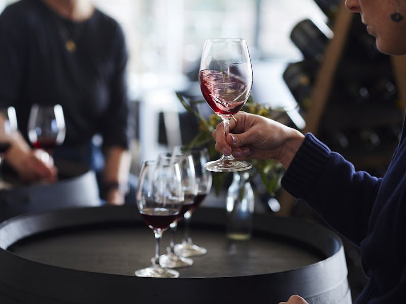 Girl swirling glass of red wine