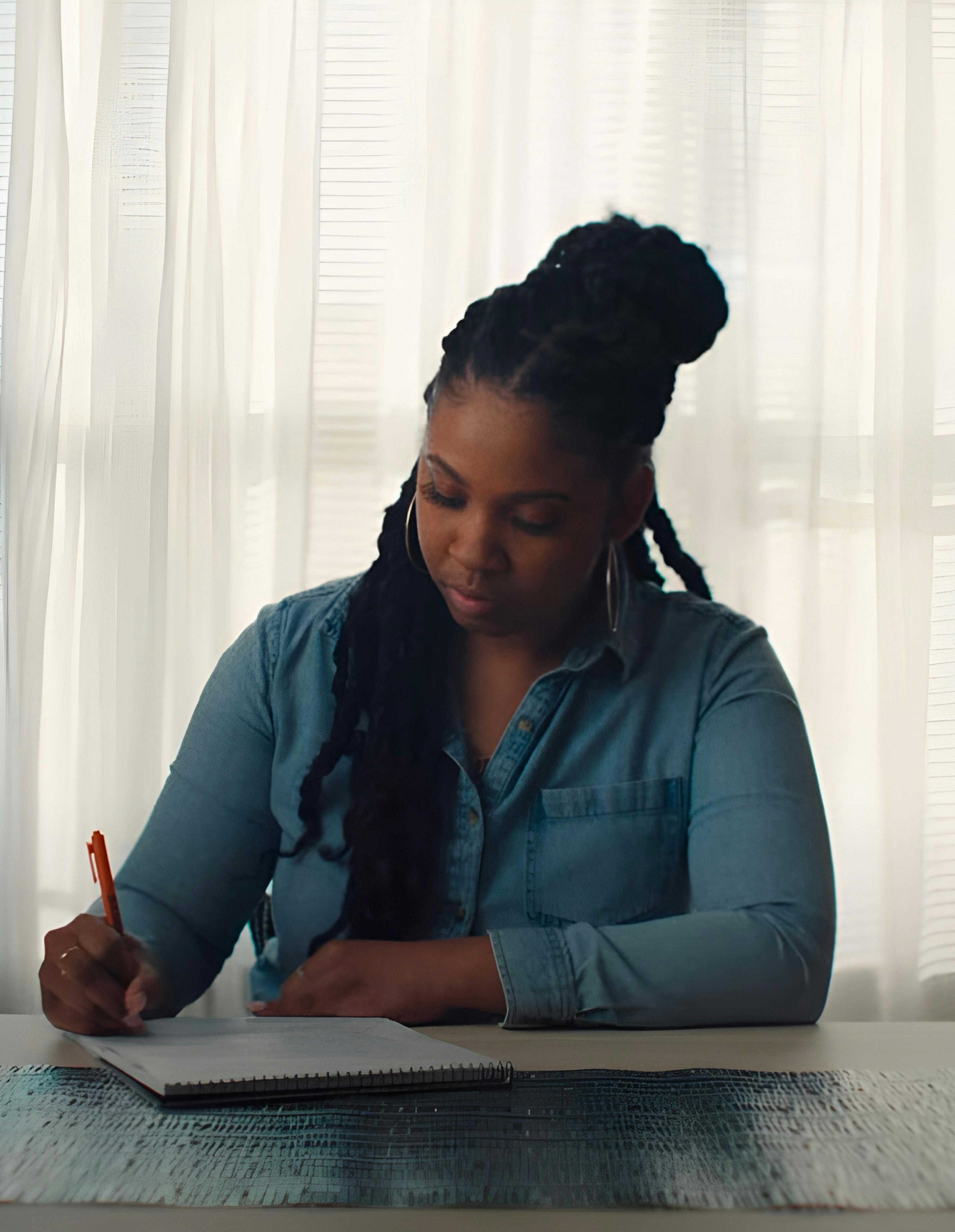 Woman signing a paper