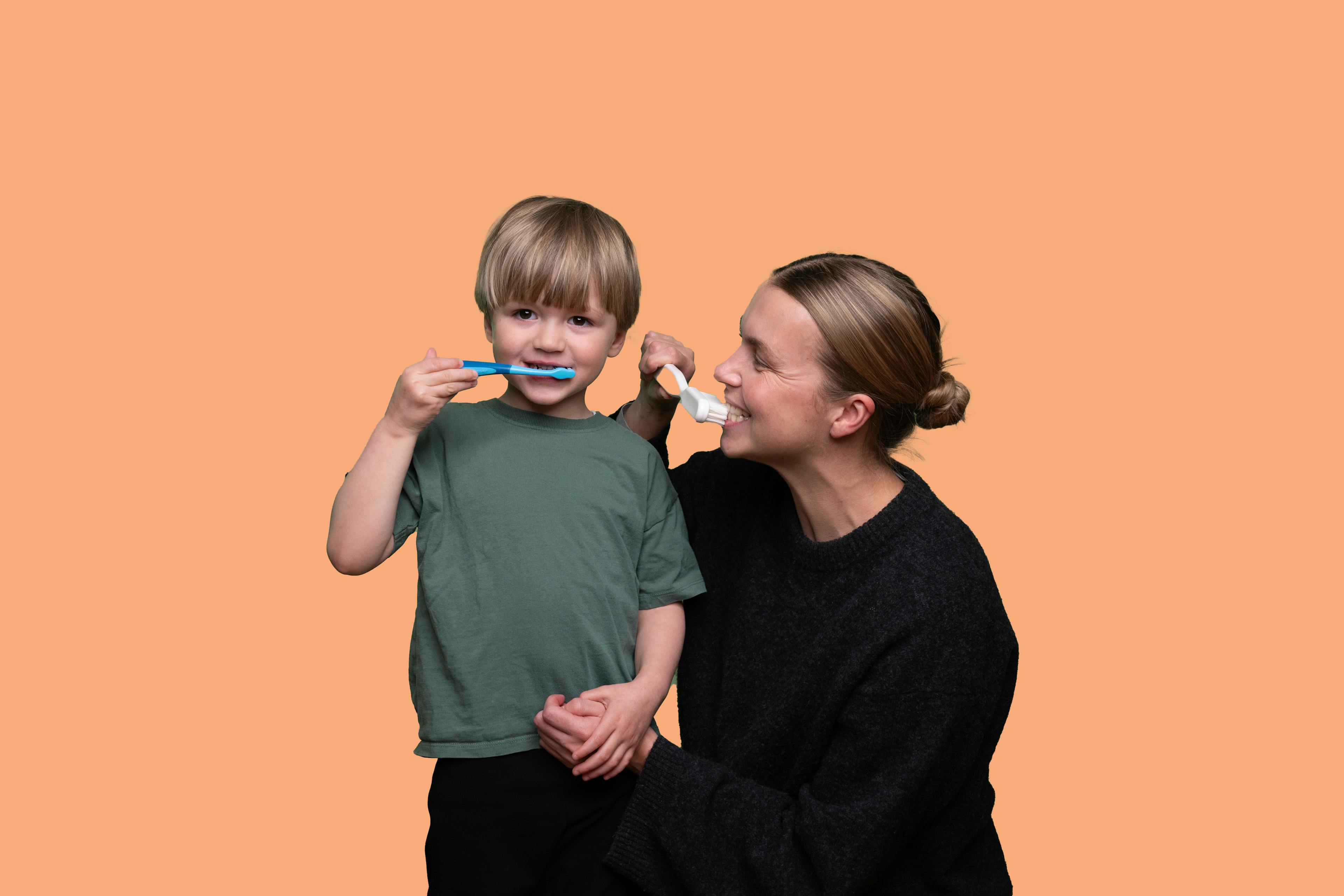 Mother and son brushing teeth