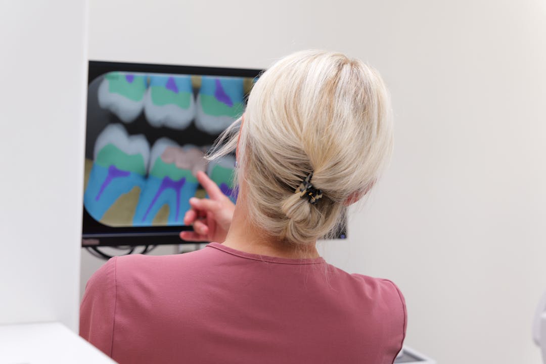 dentist pointing at screen