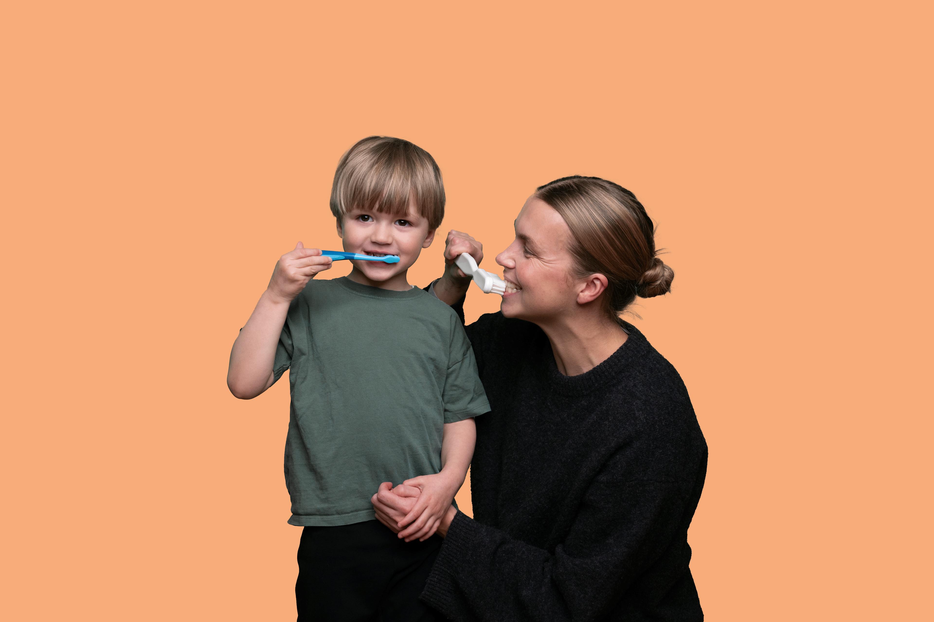 Mother and son brushing teeth