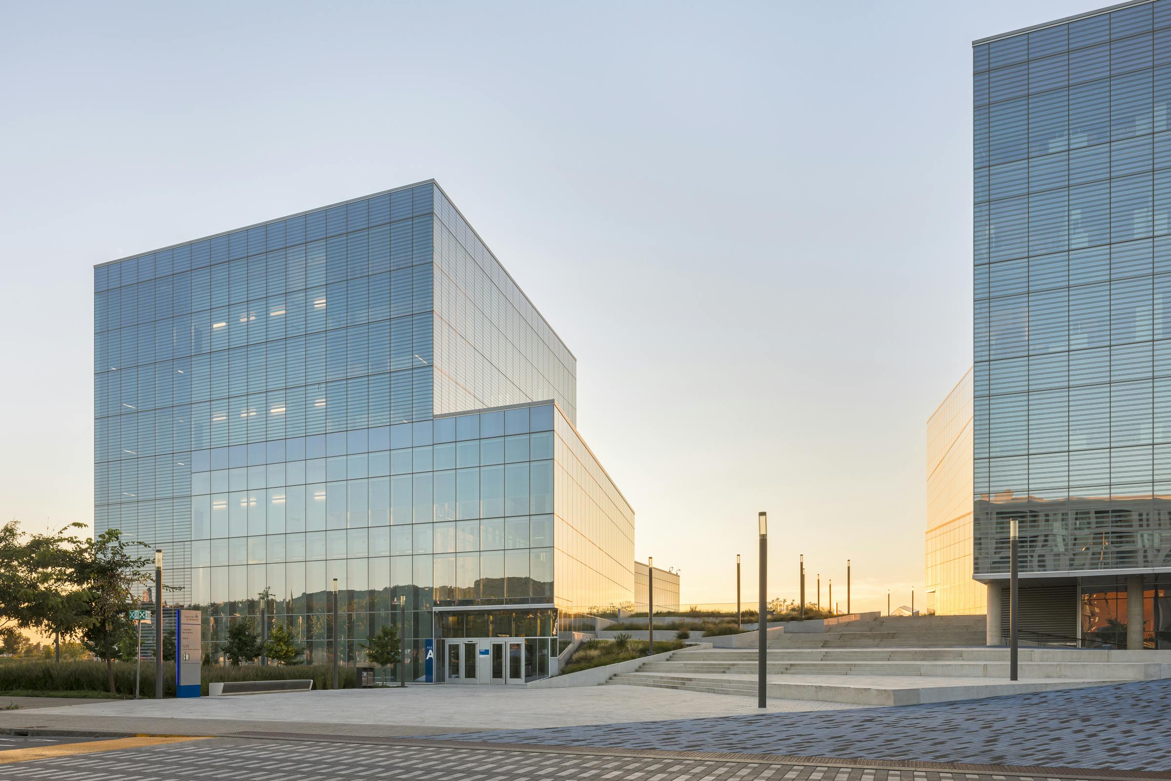 View of Pavilion A of the new science campus with the setting sun in the background.