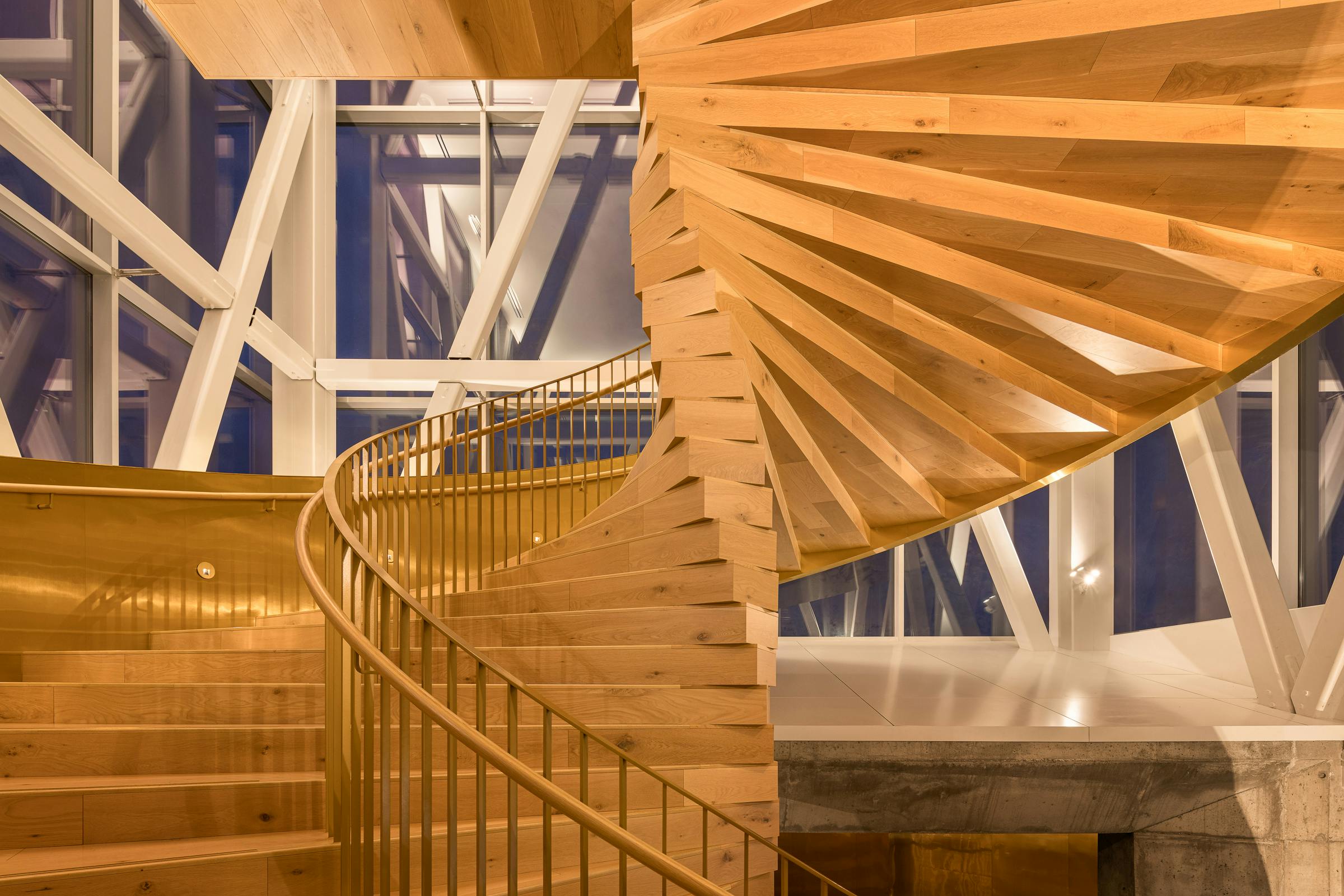 Architectural photograph of a wooden spiral staircase.