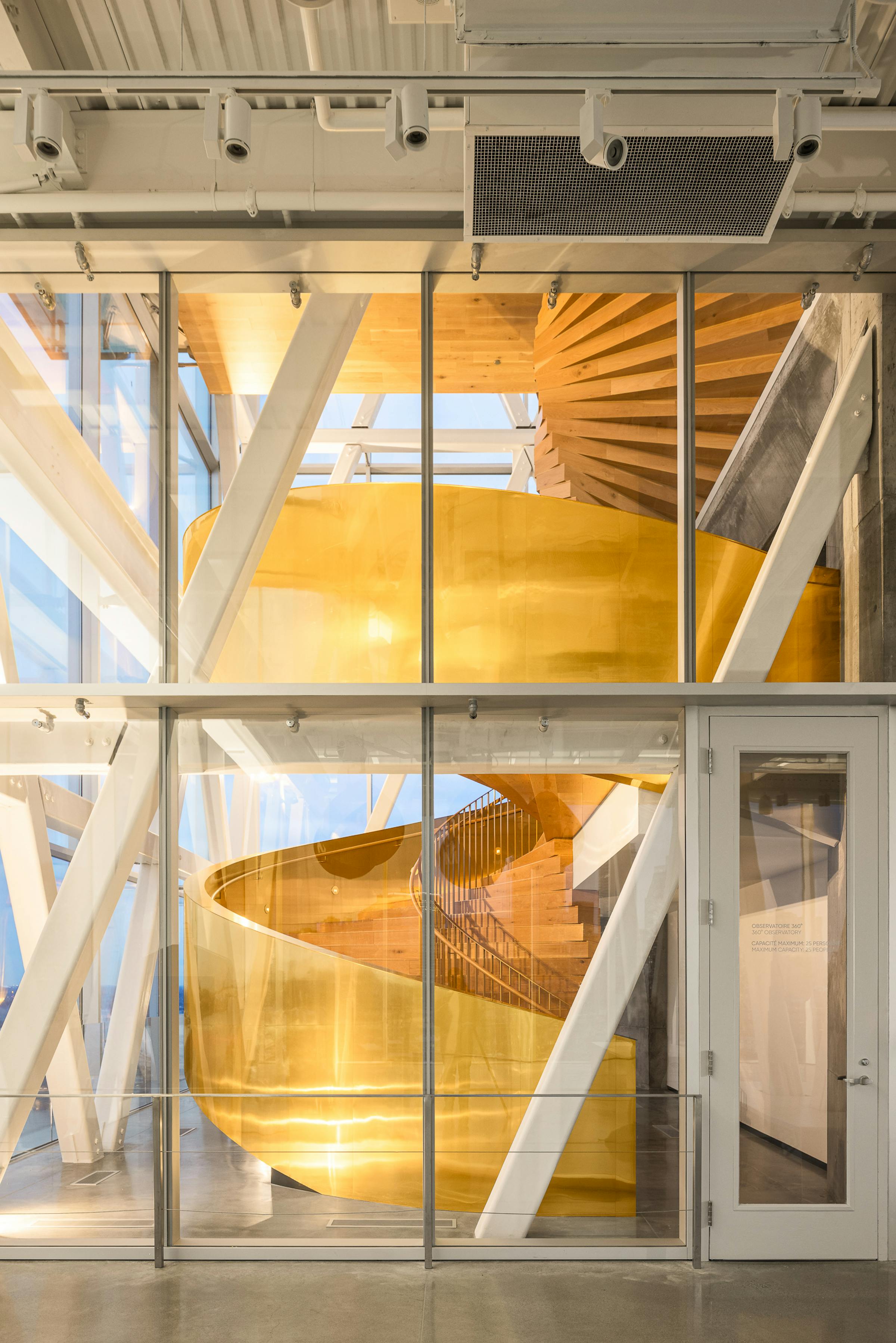 Architecture of a golden helical staircase seen through a glass surface. Apparent structure.