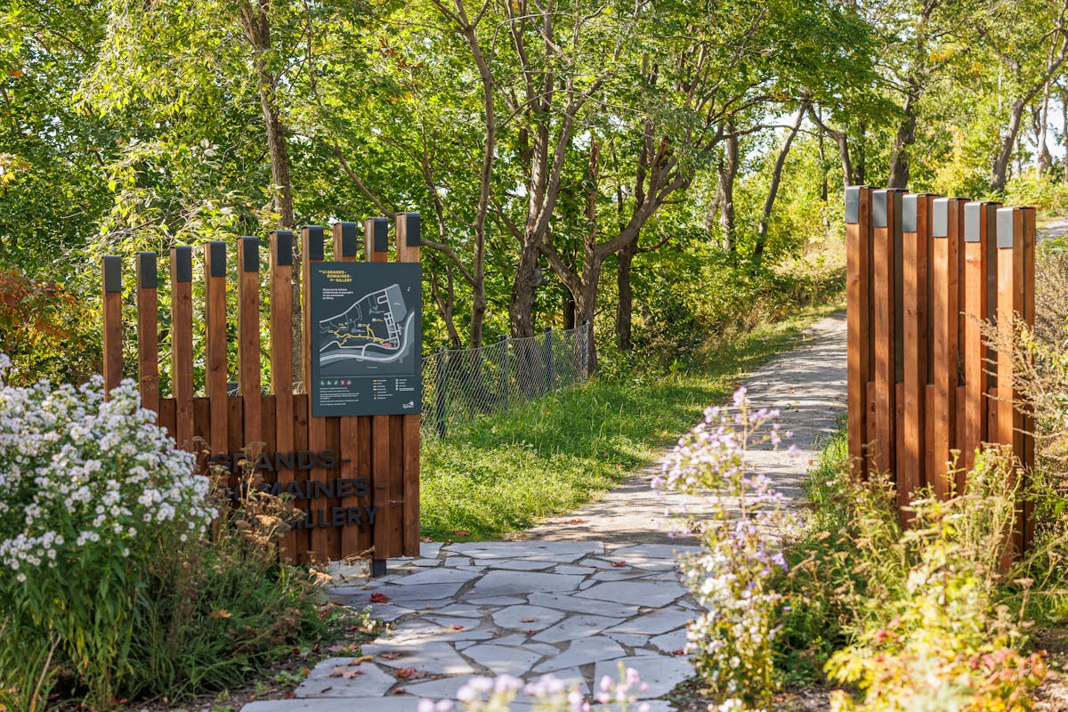 Landscaping of a path with a solid wood gate.