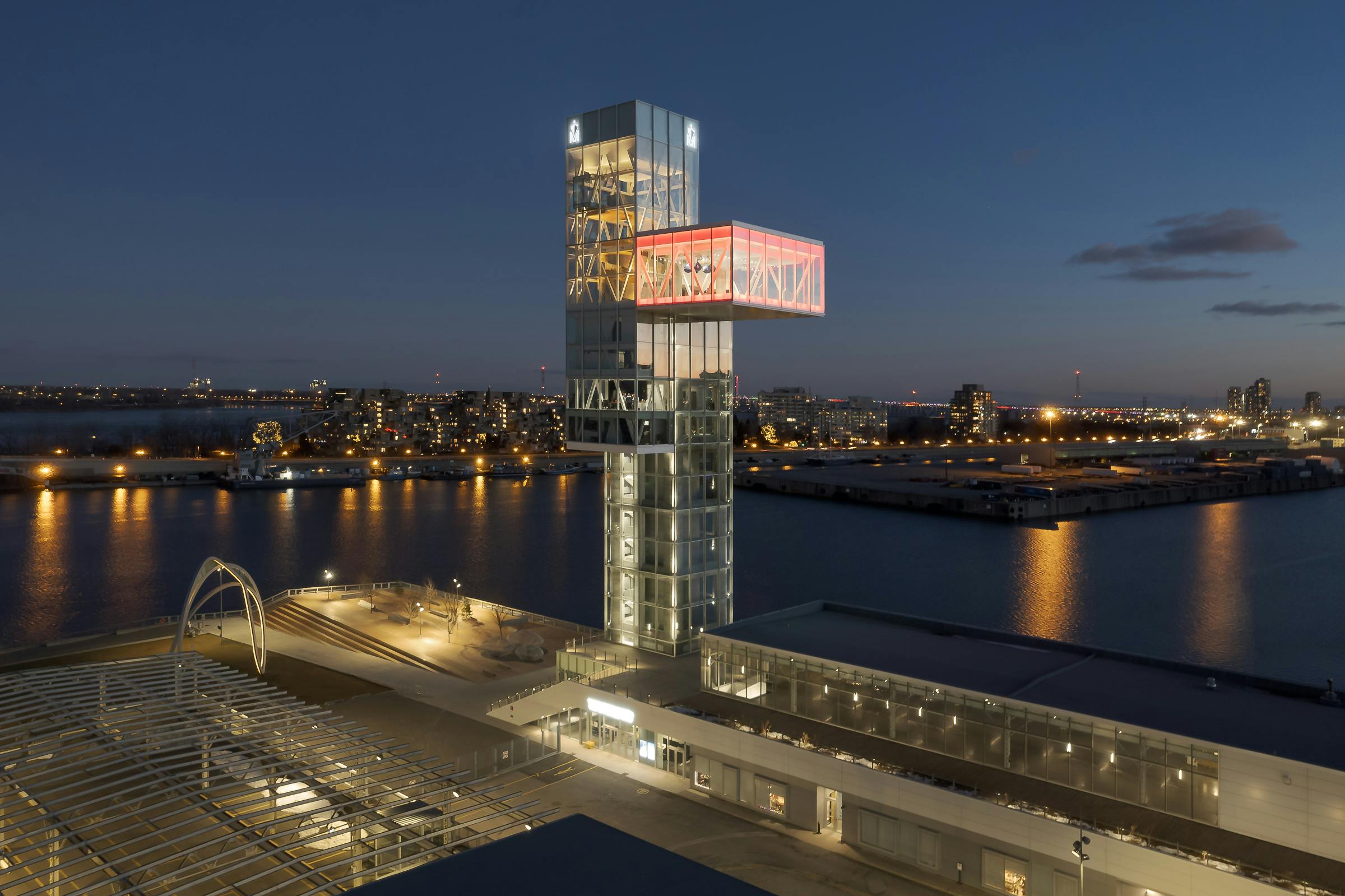 Aerial night photography of the Montreal port tower. The St. Lawrence River in the background.
