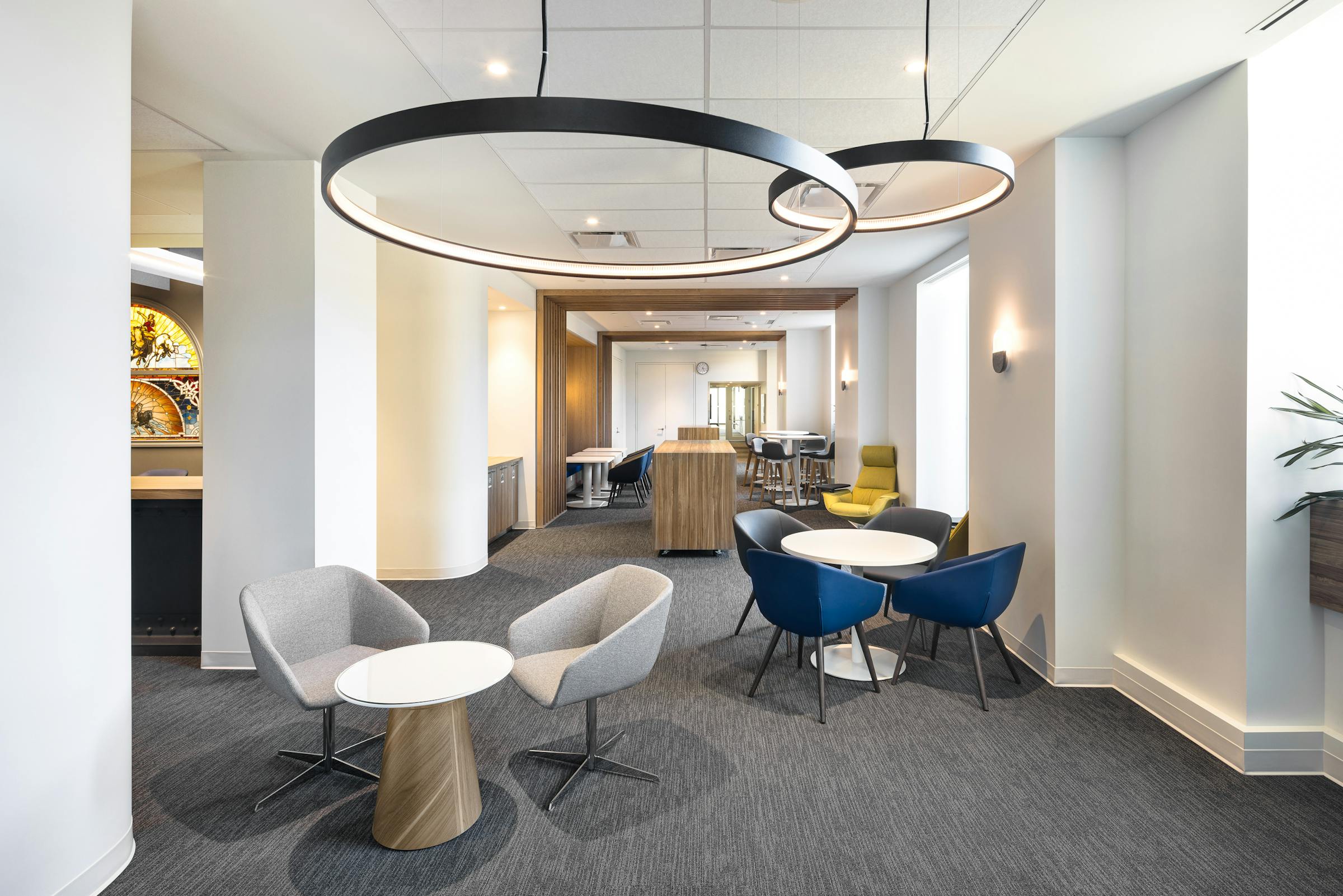 Photograph of designer office common areas with architectural ceiling lighting.