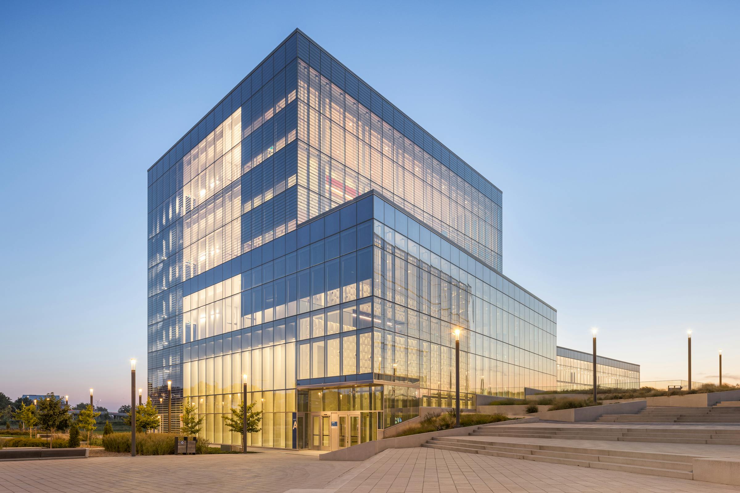 Night photography of the architecture of a glass building. Interior lighting is very present.