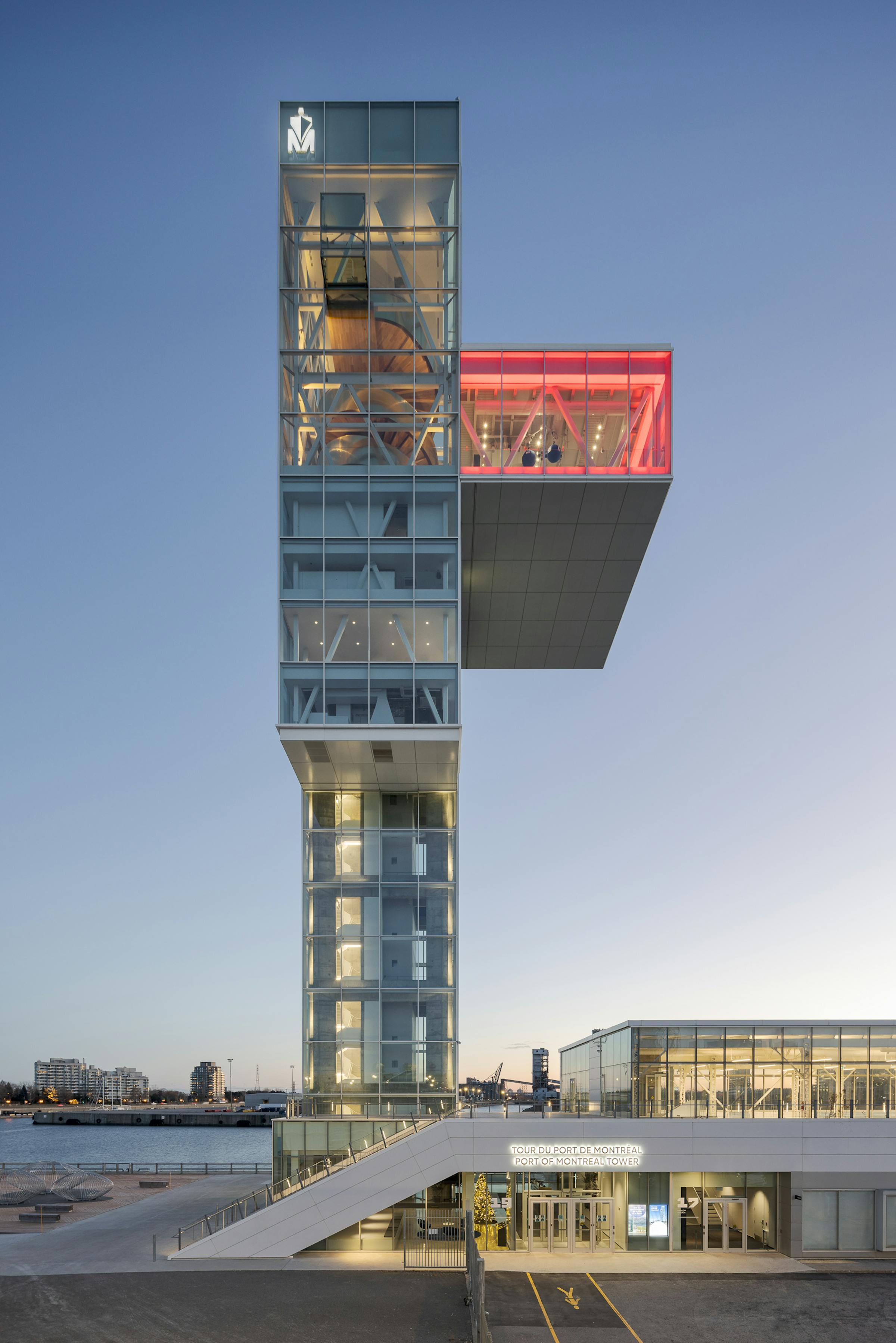 Architectural photograph of the Montreal Port Tower after sunset. The cantilevered observation room is clearly visible.