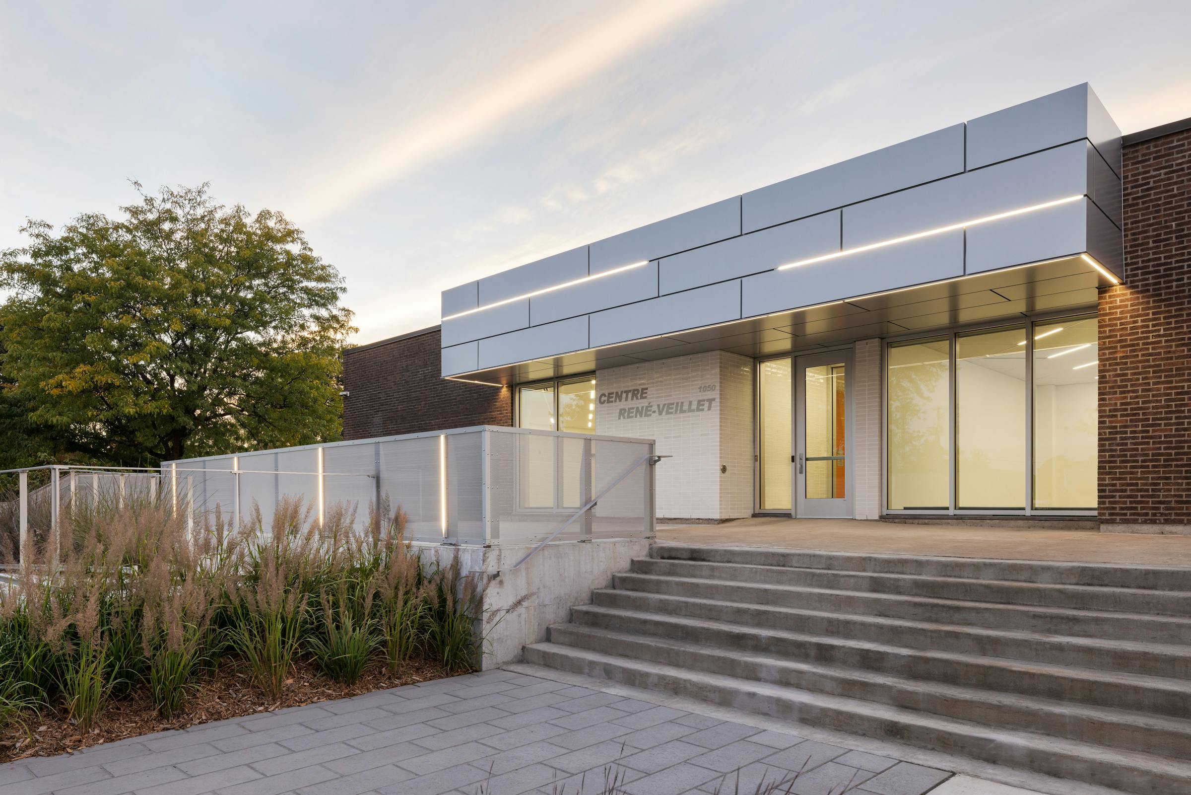 Architectural photography of the facade of an institutional building at an angle with stairs in the foreground
