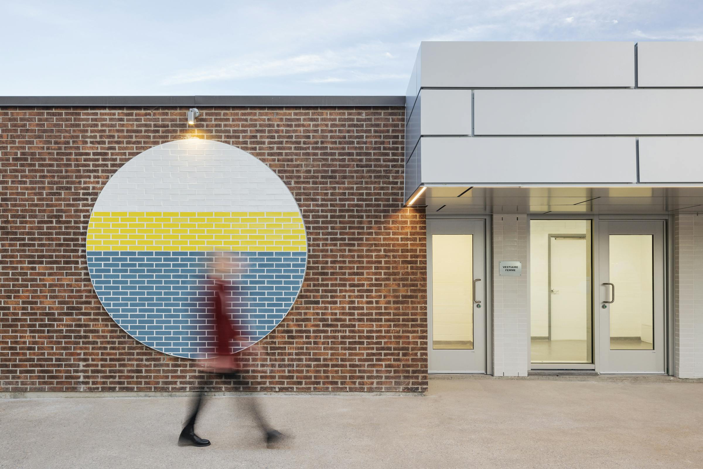 Details of an architectural element on the facade of a building with a moving silhouette.