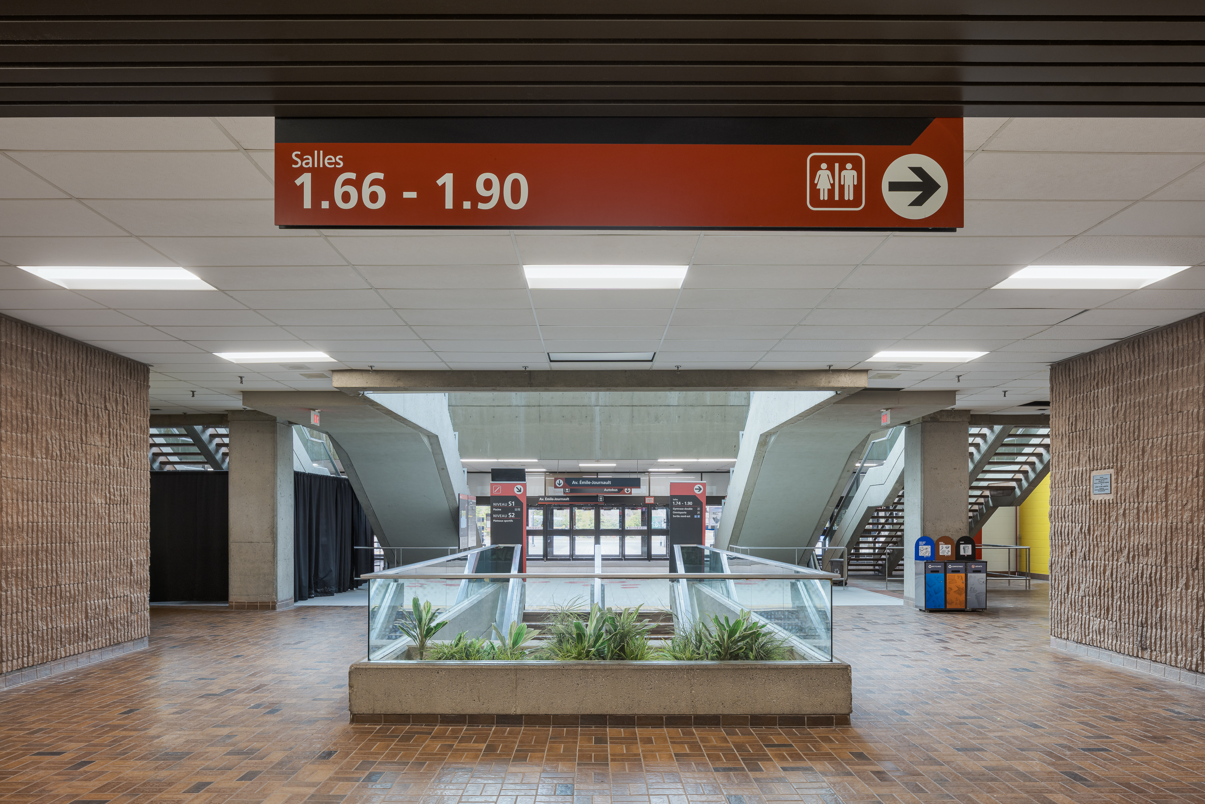 Architectural and signage photography, orientation panels in a corridor of the Claude-Robillard sports complex.
