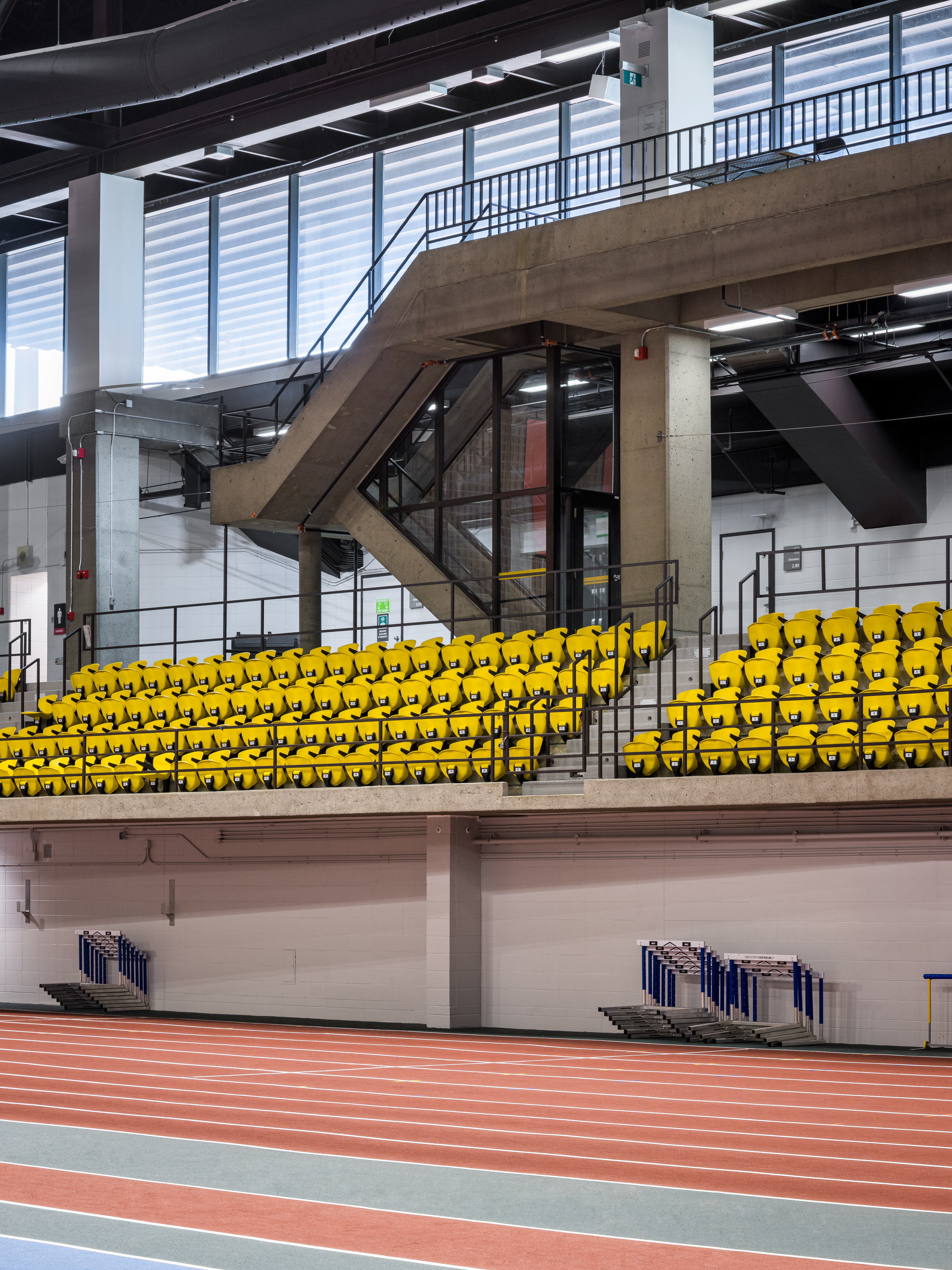 Architectural photograph, structural steel staircase leading to the stands of the multi-sports hall.