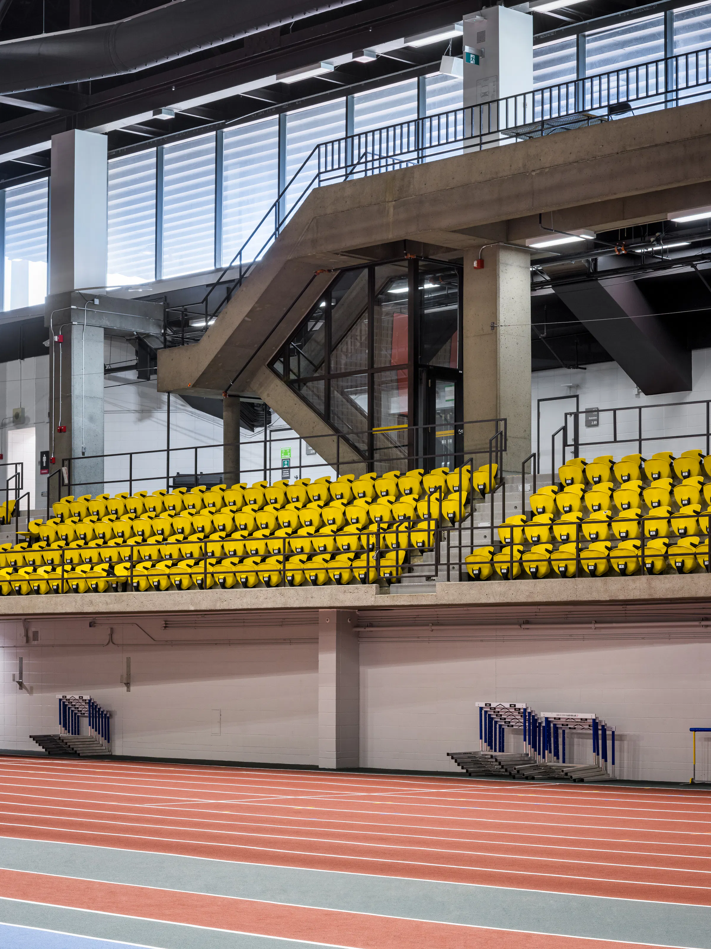 Architectural photograph, structural steel staircase leading to the stands of the multi-sports hall.