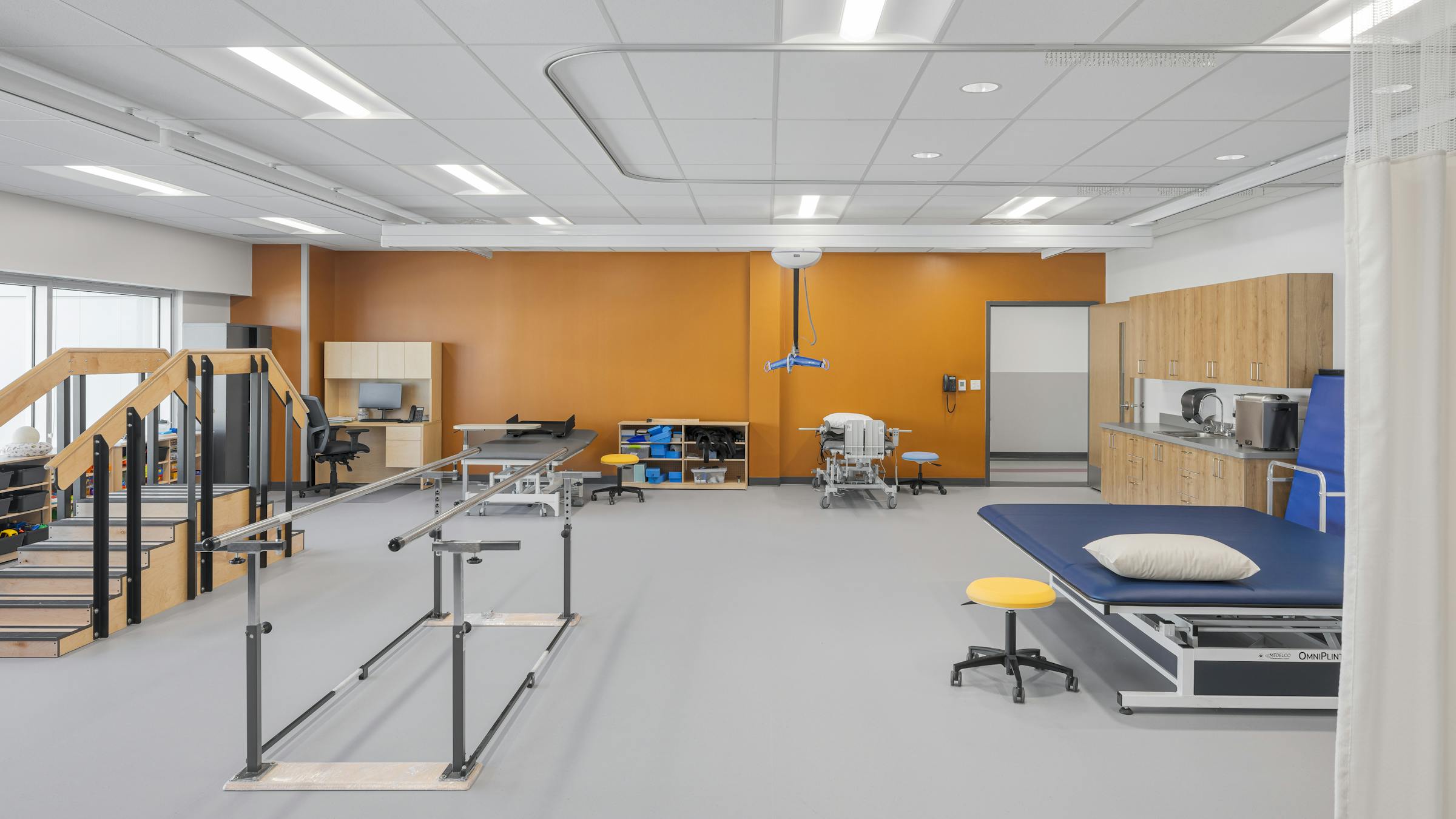 Vue d’une salle d’ergothérapie, exemple d’un environnement éducatif spécialisé à l’architecture sobre et bienveillante.